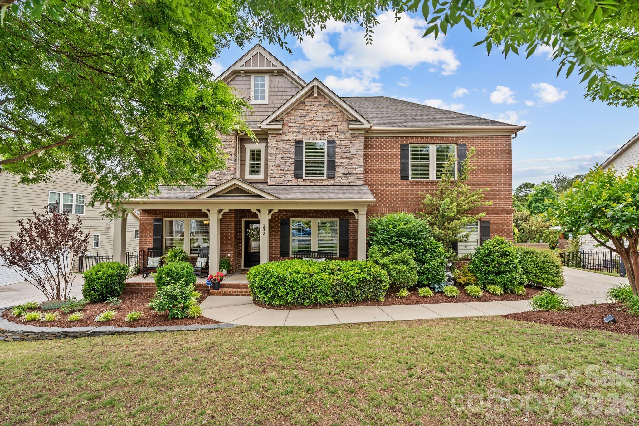 This home is in one of the Carolinas' most desirable areas, with award-winning schools nearby. This home is positioned just off Stonecrest Boulevard, where they are building The Grove at Tega Cay, a 55-acre mixed-use development bringing dining, entertainment, and community spaces right to your doorstep. It's anticipated to open by the end of 2026, according to Tega Cay's website.

This meticulously designed home features an open-concept floorplan with the primary bedroom on the main level, along with a conveniently located laundry room. The spacious kitchen anchors the home with granite countertops, a large island, ample cabinetry, and seamless flow into the living room centered around a cozy fireplace—all filled with natural light from large windows.

Step outside to a screened-in porch overlooking the backyard—perfect for relaxing evenings without the bugs—along with an extended deck with BRAND NEW Trex flooring, ideal for grilling or soaking up the sun. The main level also includes a versatile flex room perfect for a home office and a formal dining space with coffered ceilings and wainscoting, adding a refined touch.

Upstairs, a large landing space connects five generously sized bedrooms, many featuring walk-in closets. One room has been converted into a fully equipped theater space with a projector and surround sound wiring—also ideal for a GOLF SIMULATOR or the ultimate GAME/HOBBY ROOM.

Downstairs is the unfinished basement, already wired and set up for plumbing! With endless amounts of storage and possibilities, this area is a BLANK CANVAS to have that space you've always wanted, whether that is a gym, entertainment area, or additional living quarters.

Out back, enjoy your patio with string lights to create the perfect ambiance! This fenced yard has a flat area perfect for pets, play, or entertaining, meaning this house will be the place ALL of your friends and family will want to hang out at! Beyond the fence, additional wooded space adds privacy and a natural retreat feel.

This home was already highly desirable, but with The Grove at Tega Cay being built so close by, it just became irresistible. Get in now before it's too late, and experience the perfectly balanced lifestyle this home offers!