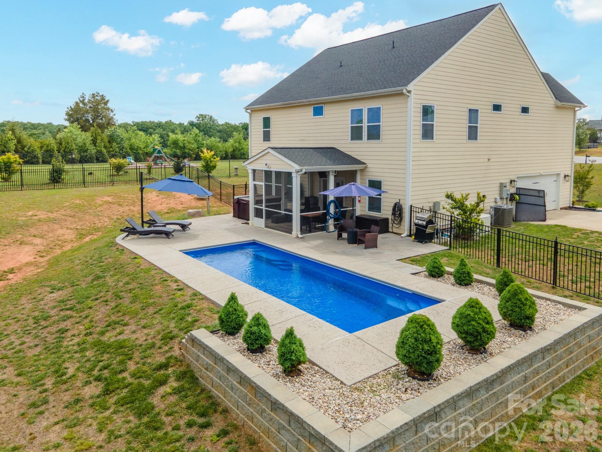 Welcome to 3774 Old Village Drive in Maiden, NC, located in the highly desirable Old Village community where homes rarely hit the market. This beautifully maintained home offers the perfect mix of comfort, style, and everyday luxury. Featuring 4 bedrooms and 3.5 baths with over 3,000 square feet of living space on a 0.99-acre lot, this home sits in the North Lincoln Middle and High School district.
The open floor plan features a spacious living room with coffered ceilings and a shiplap fireplace that creates a warm and inviting centerpiece. The kitchen is designed to impress with custom white cabinetry, granite countertops, subway tile backsplash, stainless steel appliances, and a large island perfect for gathering and entertaining. Main-level office and formal dining room add both function and elegance.
The oversized primary suite includes a spa-like bath, tile shower, and large walk-in closet. The upstairs loft offers great flex space. A Generac whole house generator has also been installed, adding comfort and peace of mind.
Step outside to your private backyard retreat featuring a fully fenced yard, beautiful in-ground pool, enclosed rear porch, and large cul-de-sac lot. A rare opportunity in one of Maiden’s most sought-after neighborhoods.