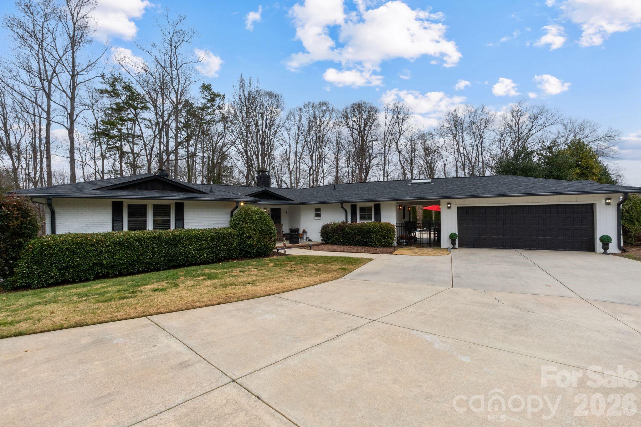 Located in the desirable The Bluffs on Dutchman Creek, this beautifully maintained white brick ranch offers the perfect balance of space, privacy, and location. This home proves you don’t have to sacrifice room to stay local in Rock Hill.

Designed for effortless living, the open-concept layout features a spacious kitchen that flows seamlessly into the main living area, ideal for everyday living and entertaining alike. The primary suite feels like a private retreat, offering generous space and comfort at the end of the day.

A beautiful natural light filled sunroom extends the living space and provides the perfect spot to relax while overlooking the backyard.

Step outside to enjoy your own underground pool, perfect for relaxing or hosting during the warmer months. 
A full back deck with multiple entrances from the home. A covered walkway adds both charm and functionality, enhancing the home’s thoughtful design.

While both lots on either side of this property are owned by the seller, one of the additional buildable lots next door is included (805), providing rare flexibility for future expansion, or added privacy. Sellers are willing to sell neighboring 813 parcel as well.