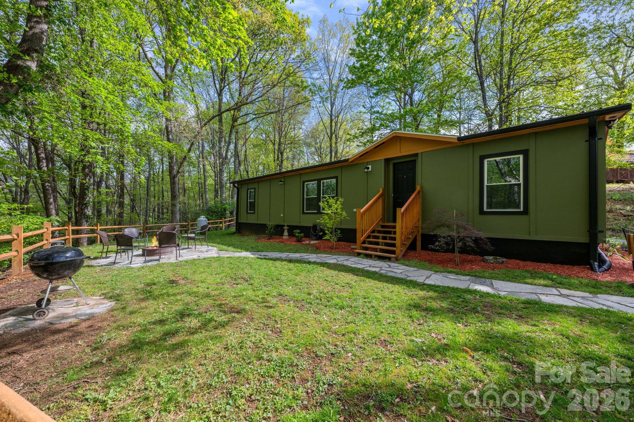 This is the one buyers keep asking for…updated, flexible, and right where you want to be. Just 5 minutes to New Market Center and under 10 to Appalachian State University and Downtown Boone, this fully updated home delivers the rare combo of peaceful woods and everyday convenience. Set on a beautifully landscaped lot with a firepit area, the setting strikes that perfect High Country balance…quiet when you want it, close to everything when you need it. Inside, the home has been completely refreshed with an open, easy-flow layout. The kitchen is a standout with stone countertops, new appliances, and a seamless connection to the living space...great for hosting or everyday living. With 3 bedrooms and 2 full baths, the layout is both functional and comfortable. And the best part? The heavy lifting is done. New windows. New flooring. New Plumbing. New Electric. Enclosed crawl space. New heat pump. Every detail has been handled so you don’t have to. No restrictions means flexibility. Use it how you want. It’s been a primary home, and as of March, a short-term rental with strong 5-star reviews already in place. Struggling to find a great rental for your App State student? Looking for a low-maintenance investment? Or just want a move-in ready mountain home that checks all the boxes? This one does it all.
