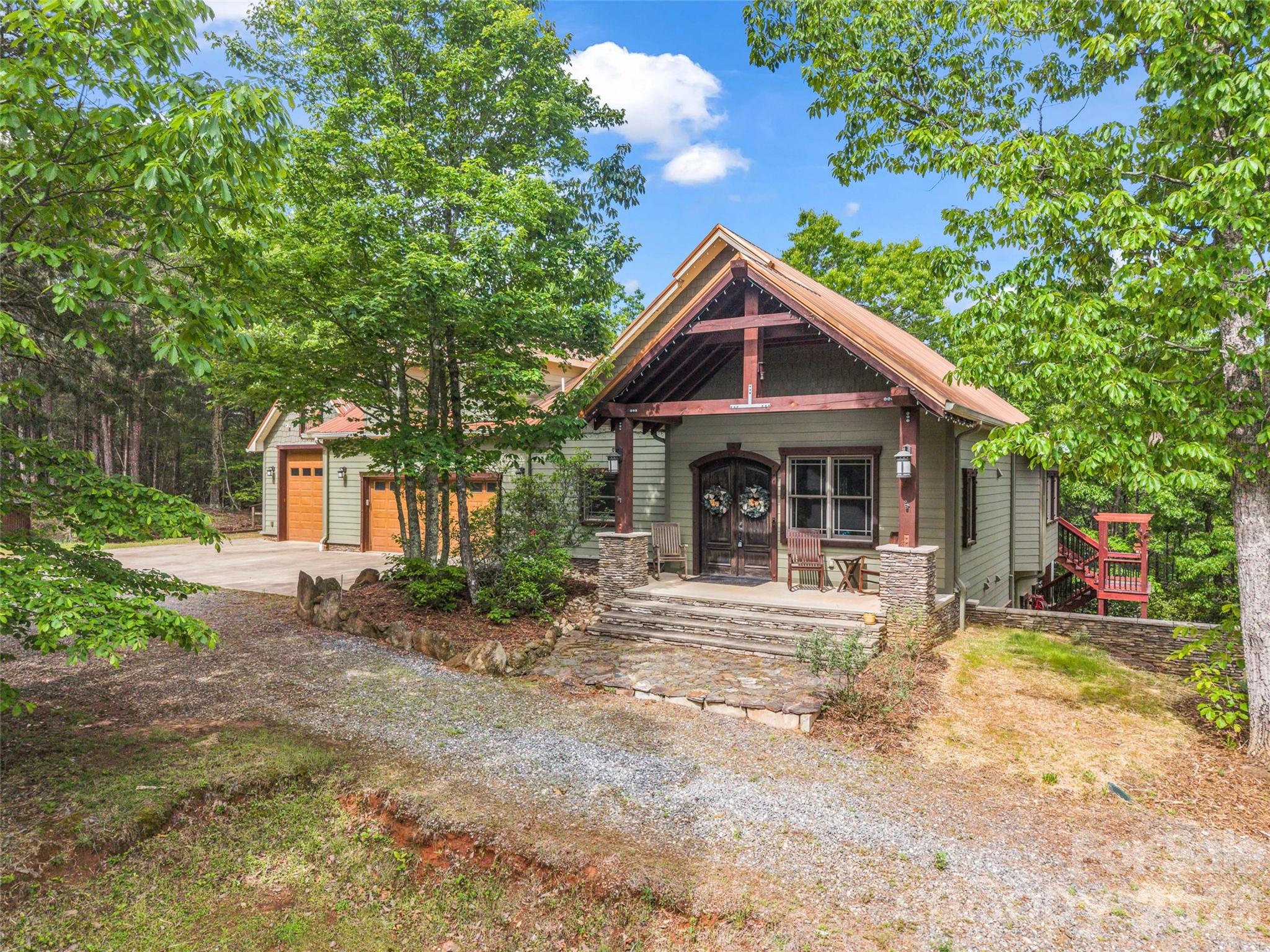 Welcome to Casa L'Aquila. Set behind the gates of Twelve Mile Post, accessed by a picturesque, covered bridge over the Broad River, this exceptional 13+ acre estate offers privacy and refined mountain living. This thoughtfully designed  home features a main level primary suite and an open-concept design anchored by a statement kitchen and hotel-style bar complete with a 3-tap, glycol keg system—ideal for entertaining. A striking custom staircase leads to an upper-level bonus room, while the lower level hosts three additional bedrooms and a distinctive wine room with arched mural ceiling and French oak barrel sink. Built for performance and longevity with near zero landfill construction. Some of the homes unique features include an IR-reflective micronized copper steel bonded roof, full open-cell foam insulation, and a heated 3-car garage. Explore the property and enjoy a stocked spring-fed pond, historic whiskey ruins, and a truly one-of-a-kind setting.