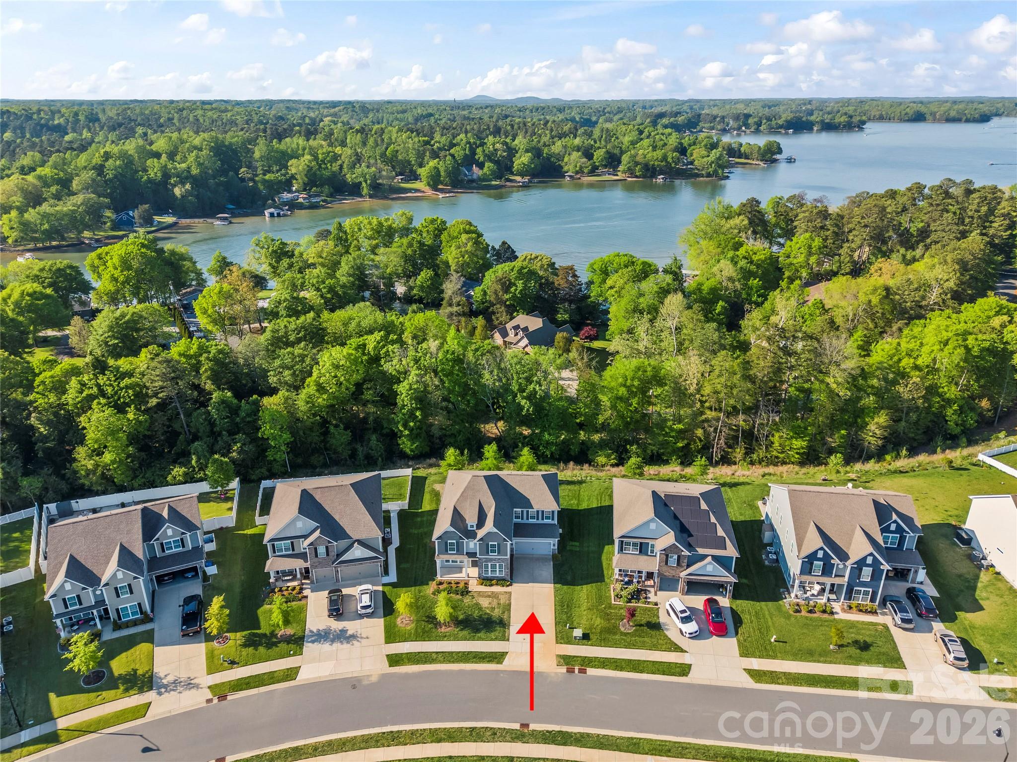 Experience refined living in the highly sought-after Cypress Point pocket, where everyday life includes a signature community pool, pickle ball and neighborhood events. Ideally located in the heart of Lake Wylie, you’re just minutes from shopping, dining, Top-Rated Clover Schools, and nearby marinas for easy lake access. This move-in ready 5-bedroom, 4.5 bath home with a spacious bonus room offers an open-concept main level designed for both comfort and entertaining. The layout features a dedicated office and main-level guest suite, along with high-end finishes throughout including an open floor plan, prefinished wood flooring, quartz kitchen countertops, stainless steel appliances, double ovens, a gas cooktop, and an expansive quartz kitchen island. Fresh paint and brand-new carpet make this home truly turnkey. Step outside to your low maintenance backyard retreat featuring a built-in grill station perfect for entertaining while enjoying seasonal water views. All just a convenient drive to Charlotte and CLT Airport. You'll want to make this one your next home!
