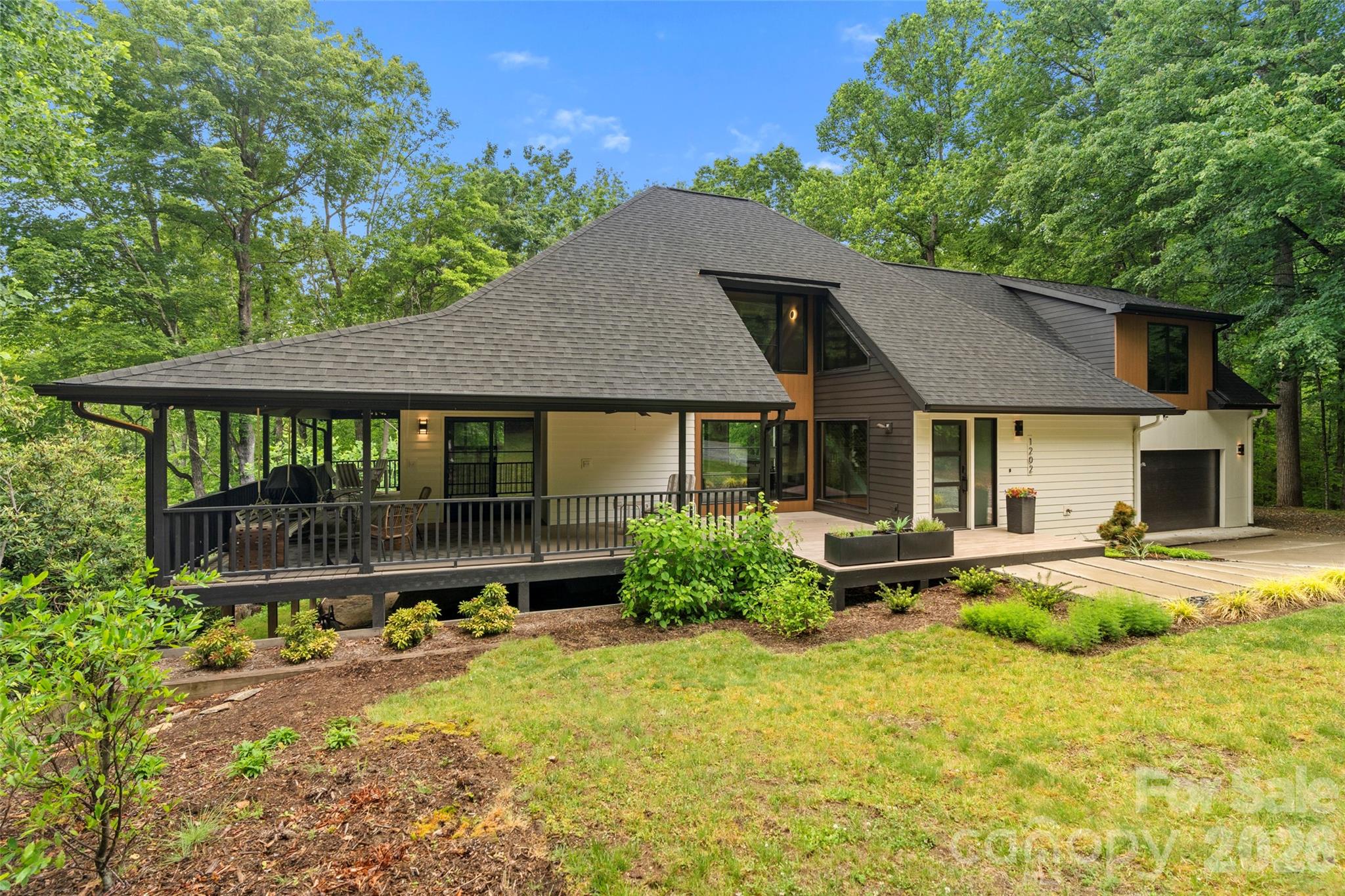 Set on 5.74 acres, this move-in-ready home offers year-round mountain views and stunning sunsets. Designed in a refined Japandi style, it blends modern amenities with mid-century inspiration. Terrazzo and white oak flooring enhance the light-filled interior, complemented by oversized windows throughout. The kitchen features a high-end appliance package, workstation sink and large pantry. The primary suite is a private retreat with its own deck, spa-like bath with heated floors, and a spacious closet with custom cabinetry. Outdoor living includes a covered wraparound porch and large rear deck ideal for enjoying the scenery. Additional features include a generator and exceptional privacy, making this an ideal full-time residence or mountain escape!