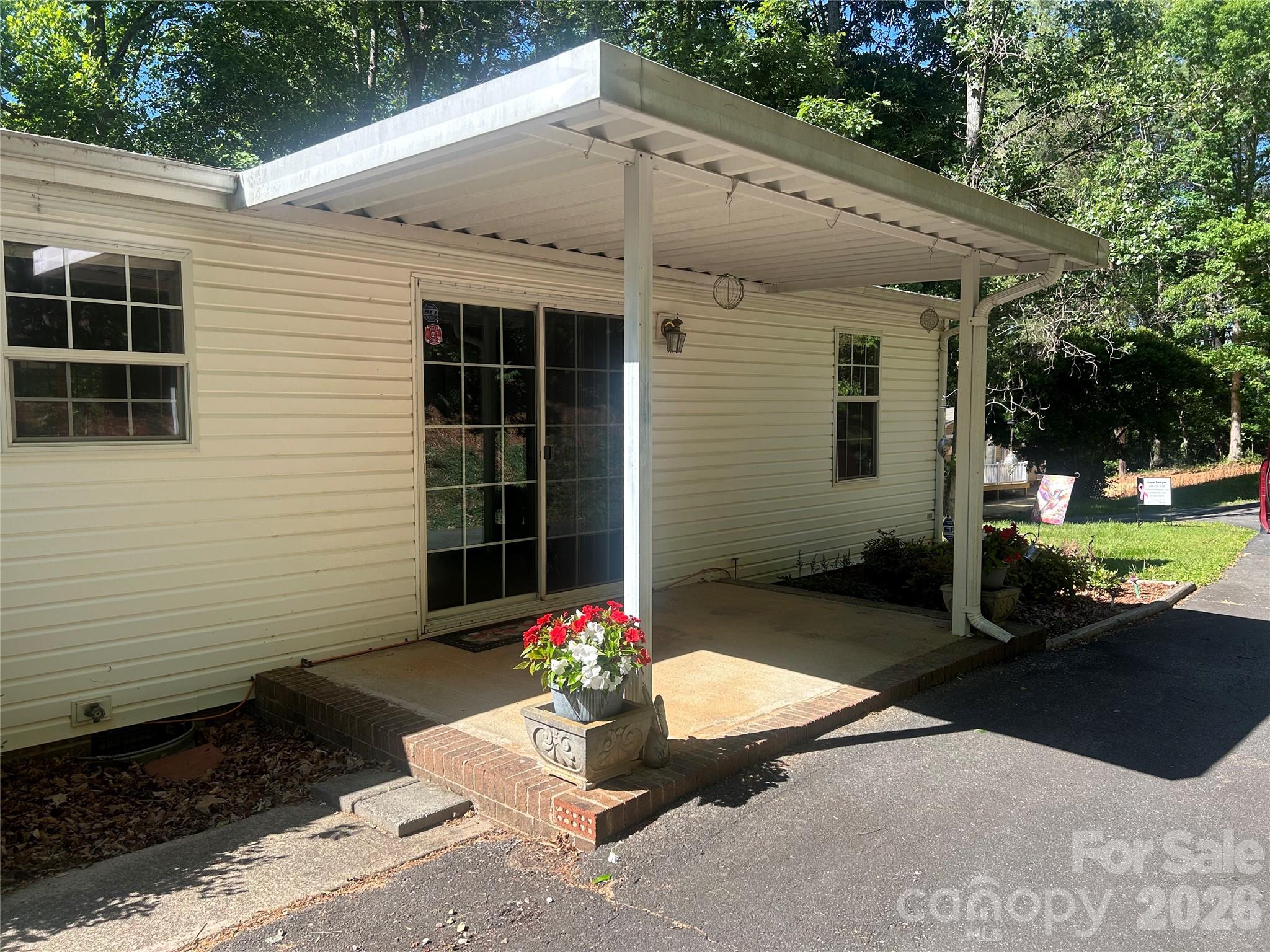 Welcome to your new home in the desirable Drexel area, a community within Burke County and adjacent to the mountain town of Morganton! Pride of ownership shines in this well-maintained, three-bedroom, two-bath, double-wide mobile home, owned and lovingly cared for by the same owner for nearly 30 years. New roof in 2024! Sliding glass door by the dining area provides additional light to the home. You won't believe the number of cabinets and storage in the kitchen, including a pantry.  The kitchen is also highlighted by a tasteful ceramic backsplash. At the end of the counter top, an extended dining area is attached for added seating.  Appliances include refrigerator, dishwasher, electric range. The vast living room, with views of the woods, includes a cultured stone, gas fireplace for added coziness during the cold, winter days (gas logs have never been used!). The primary bathroom features a custom walk-in shower.   Ceiling fans throughout!  Central HVAC for added comfort. City water! The residence sits on a private, one-acre wooded lot at the end of a paved, private drive offering exceptional peace and seclusion. A real plus is that this residence is under-bricked for a solid foundation!  Additional awesome features include a single-car carport, a large storage building, and generous outdoor living spaces.  Enjoy the peace and quiet of this neighborhood from the spacious covered front deck.  This property offers a rare combination of privacy and functionality. Long- and short-term rentals permitted. Located less than 15 minutes to Interstate 40. Drexel is an outdoor-activity-oriented community making this home ideal as a full-time residence or a peaceful retreat close to nature.  Sold unfurnished. Drexel centers on outdoor beauty, local history, and community events, with nearby attractions like McGalliard Falls Park, the Waldensian Heritage Trail & Museum, local farms, wineries, Lake James State Park, and the annual Drexel Fair offering nature, culture, and family entertainment.  Additional High Country communities located less than an hour from this residence include Blowing Rock, Boone, Banner Elk, App State University (Hickory & Boone), and Linville (Linville Gorge).  This is an ideal home offering a picturesque location with access to all amenities of the High Country.   Schedule your showing today!