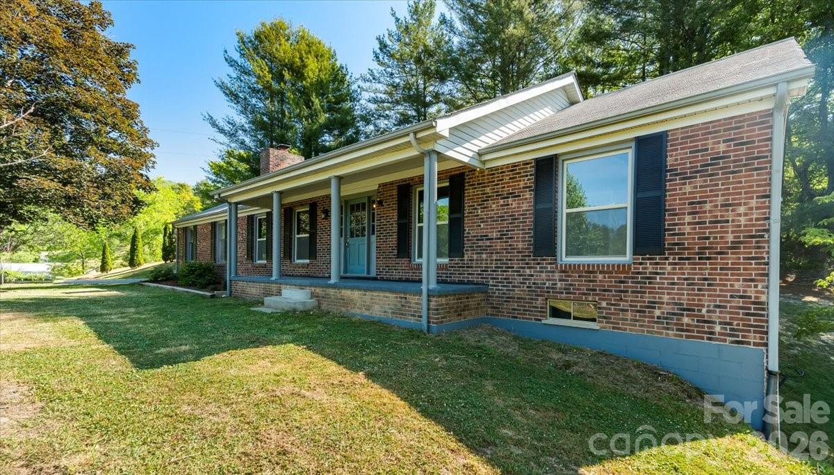 Tucked away in the tranquil town of Spruce Pine, this newly renovated beautiful brick ranch is a true gem. So many updates; new windows, beautiful new crown moulding throughout , new septic, new water pump along with a new pressure tank, new doors. Boasting over 1450 sq ft of thoughtfully designed, newly painted living space, this gorgeous home features 3 spacious bedrooms with large closets, 2 exquisitely updated bathrooms. The functional open-concept floor plan is bathed in natural light, showcasing a warm brick fireplace, and a lovely open kitchen. This kitchen is a showstopper with exquisite custom cabinetry, gleaming countertops and stainless steel appliances. A spacious oversized 2 car garage and newly loxon-sealed unfinished basement offer endless possibilities for expansion. Surrounded by a quiet and soothing neighbohood, this serene retreat is just moments from town, perfectly balancing peaceful seclusion with modern convenience. Don’t miss your chance to call this dream home yours!