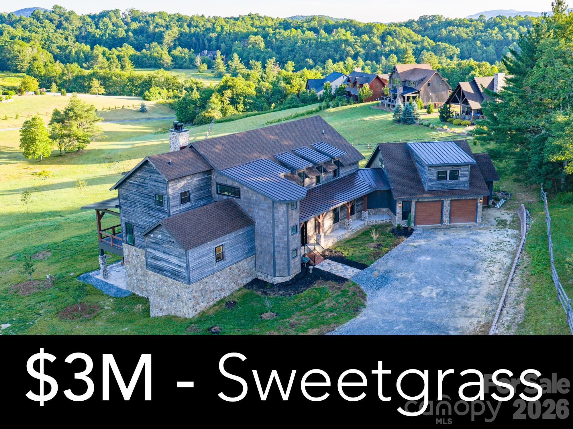 Masterpiece in Sweetgrass! Welcome to an extraordinary custom-built mountain estate offering **5,043 heated square feet, plus an additional 594-square-foot above-garage in-law suite, and an additional 3,071-square-foot unfinished walkout basement** already framed and insulated for future expansion. Situated on one of the most unique homesites in the community, this is the **only property permitted to have a fence, barn, and horses**—a grandfathered provision established by the original builder, who intended this to be his personal homesite. A picturesque drive lined with mature apple trees welcomes you home, while invisible fencing provides convenience for pets. Crafted with exceptional attention to detail, the home showcases custom wood front and exterior doors, a stunning custom wood kitchen island, professional-grade chef's appliances, custom cabinetry throughout, high-end countertops, and a walk-in pantry with built-in storage. The thoughtfully designed floor plan features a luxurious main-level primary suite with a spa-inspired bath, custom walk-in closet, and its own gas fireplace. The private above-garage in-law suite offers a spacious bedroom, full bath, living room, and walk-in closet, providing exceptional comfort and privacy for extended family or guests. Every bathroom features custom vanities, while the spacious mudroom includes built-in storage and a dedicated dog washing station. Designed for both everyday living and entertaining, the home offers soaring ceilings, a dramatic floor-to-ceiling natural wood-burning fireplace in the main living area, two additional gas fireplaces—one in the primary suite and another in a second-floor bedroom—and the unfinished basement is already framed for future expansion, including the option for an additional fireplace utilizing the existing chimney. The home is served by both propane and electric systems. Outdoor living is equally impressive with two covered entertaining areas overlooking the peaceful mountain setting. Residents also enjoy outstanding community amenities, including a fitness center, game room with ping pong, a spacious clubhouse available for casual use or private events, and a community lake with complimentary kayaks available for residents. Combining exceptional craftsmanship, luxury finishes, unmatched flexibility, and the rare opportunity for equestrian living within a premier mountain community, this one-of-a-kind property offers a lifestyle unlike any other. **Highlights:** • 5,043 heated sq. ft. • Additional 594 sq. ft. above-garage in-law suite • Additional 3,071 sq. ft. unfinished walkout basement (framed and insulated) • Only home in the community approved for a fence, barn, and horses • Invisible pet fencing • Professional-grade chef's kitchen • Custom wood doors, cabinetry, vanities, and kitchen island. • Walk-in pantry with built-in storage • Dedicated dog washing station • Luxury primary suite with spa-inspired bath • Three fireplaces with space for a fourth • Two covered outdoor living areas • Community clubhouse, fitness center, game room, and lake with complimentary kayaks