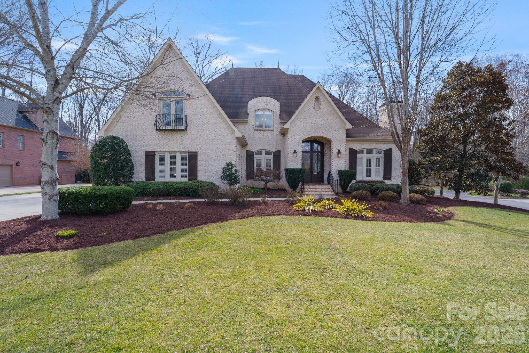 Welcome to an extraordinary residence nestled within the prestigious gated community of Providence Downs in Marvin—where luxury, privacy, and timeless elegance converge.
Perfectly positioned on a sprawling .75-acre homesite, directly next to caul-de-sac, this estate commands attention with breathtaking curb appeal and one of the most private, secluded settings in the community. From the moment you arrive, the stage is set for refined living at its finest.
Step through the double stained doors into a dramatic two-story foyer highlighted by a grand staircase and arched doorways. Newly installed wide-plank hardwood floors ( 2023) flow seamlessly throughout the main level and up the staircase, into to second floor hallway complemented by updated spindles and curated designer finishes at every turn. The private main level office is nothing short of inspiring—featuring a gas fireplace, custom built-ins, and a coffered ceiling that elevates your work-from-home experience.
At the heart of the home, the kitchen and keeping room truly steal the show. Bathed in natural light, this space balances elegance and warmth with a cozy gas fireplace and seamless flow for entertaining. Recent enhancements include a stunning quartz island, newer refrigerator, dishwasher, and microwave—offering both beauty and performance. Upstairs, you’ll find three generously sized guest suites, each with access to attached baths.  An impressive walk-in storage area off one of the guest bedrooms provides abundant organization options.  Two of the upstairs bathrooms have been fully updated with tiled showers, quartz countertops, and elevated fixtures. The versatile bonus room offers flexibility as a sixth bedroom, media space, or recreation retreat—complete with closet and attached bath. Outdoors, unwind on the covered back porch, overlooking a private backyard with ample space to design your dream pool, spa, or outdoor living retreat. The possibilities are limitless. Maintained and thoughtfully upgraded, this home includes: water filtration system, updated crawl space with vapor barrier, LVL's, insulation, dehumidifier, & air scrubbers installed in all three HVAC systems. Residents of Providence Downs enjoy top-rated schools, resort-style amenities, and an unmatched lifestyle in one of Marvin’s most sought-after communities. Showings Start Friday 2/20 at 12 noon.  Open House Saturday 2/21/26 from 11am-1pm