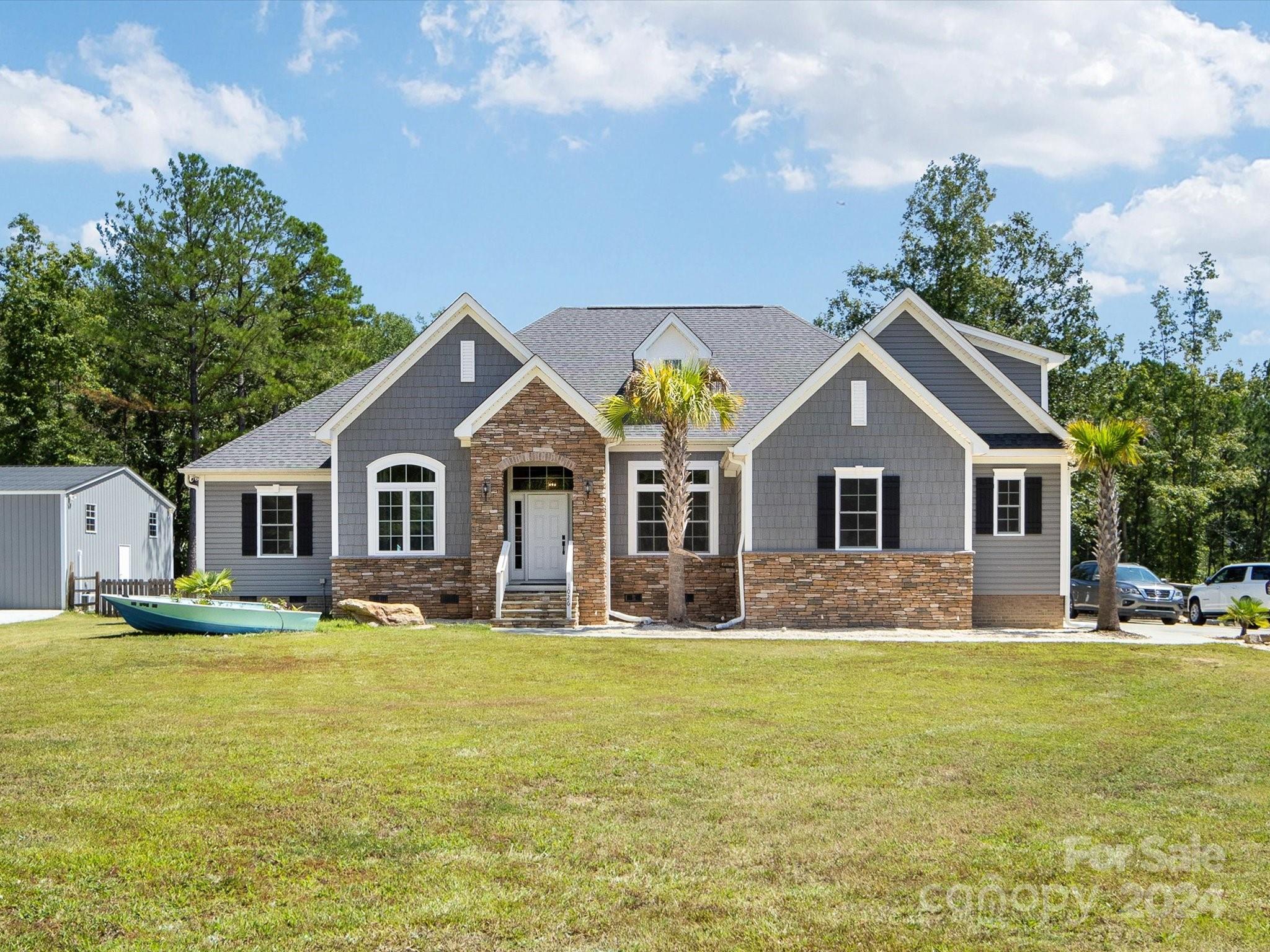 This beautiful 21 acre retreat offers so much. Come down the long driveway, you will pass through a canopy of trees to find your new home situated amidst a scenic setting of pasture, pond, trees and privacy. Before you enter this lovely Ranch style home you will be in awe of what nature provides. Imagine easy and relaxed living, the open plan offers all the space you need, natural light with plenty of windows throughout will deliver a bright and airy feel, accentuating the premium finishes. Prepare meals in the chef's kitchen, entertain guests inside or out. Take advantage of the relaxing screened porch and gaze out over the pond or into the trees. This home has 4 bedrooms on the main and sizable bonus room above the attached 2 car-garage. Need more space, escape the to 60x30 detached garage that is fitted with a private exercise studio, as well as plenty of workshop space. Go outdoors, and search for fish and turtles in the pond, explore the acreage or stroll along the wooded trails.