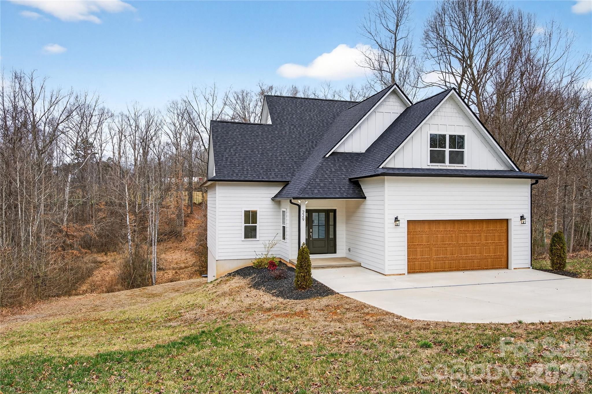 Welcome to your brand-new dream home in the charming town of Troutman! where refined design meets everyday comfort. This beautifully crafted two-story residence is set on a spacious half-acre lot along a quiet, wide street, offering privacy, space, and timeless appeal. Thoughtfully designed, the home features three bedrooms and a versatile loft upstairs, three full bathrooms with high-quality fixtures, and a convenient main-level office ideal for remote work or hosting guests. The open-concept floor plan seamlessly connects the kitchen, dining area, and family room, creating a warm and inviting space perfect for entertaining or relaxing by the fireplace. Step outside to the expansive rear deck overlooking peaceful wooded views, with no construction behind the property, an ideal setting for quiet mornings and evening gatherings. A separate septic easement keeps the system off the main lot, while superior materials and craftsmanship set this home apart. Enjoy the freedom of no HOA fees paired with the convenience of being just minutes from the State Park and major highways. This exceptional location offers easy access to urban amenities while providing the tranquility of nature at your doorstep.