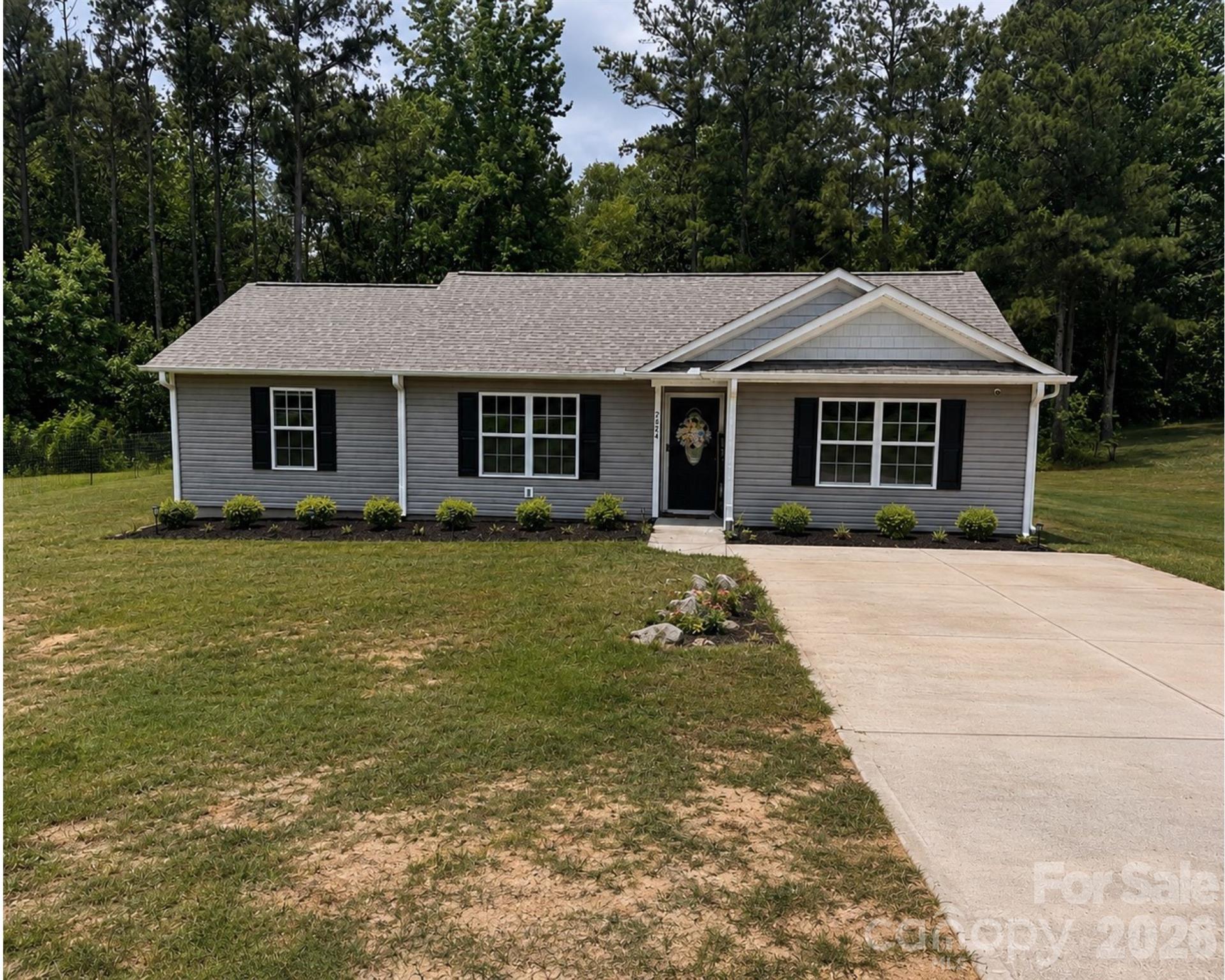 Welcome home! If you’re looking for the perfect blend of peaceful country living and convenient access to town. Built in 2022, this beautifully maintained home features an open-concept layout with a desirable split floor plan, offering privacy for the primary suite on one side of the home and two additional bedrooms on the other.
The spacious living areas flow seamlessly, making it ideal for both everyday living and entertaining. Start your mornings with a cup of coffee on the private back patio overlooking the woods, where you can relax and enjoy the tranquility of nature. Modern, comfortable, and move-in ready—this home offers the best of both worlds.