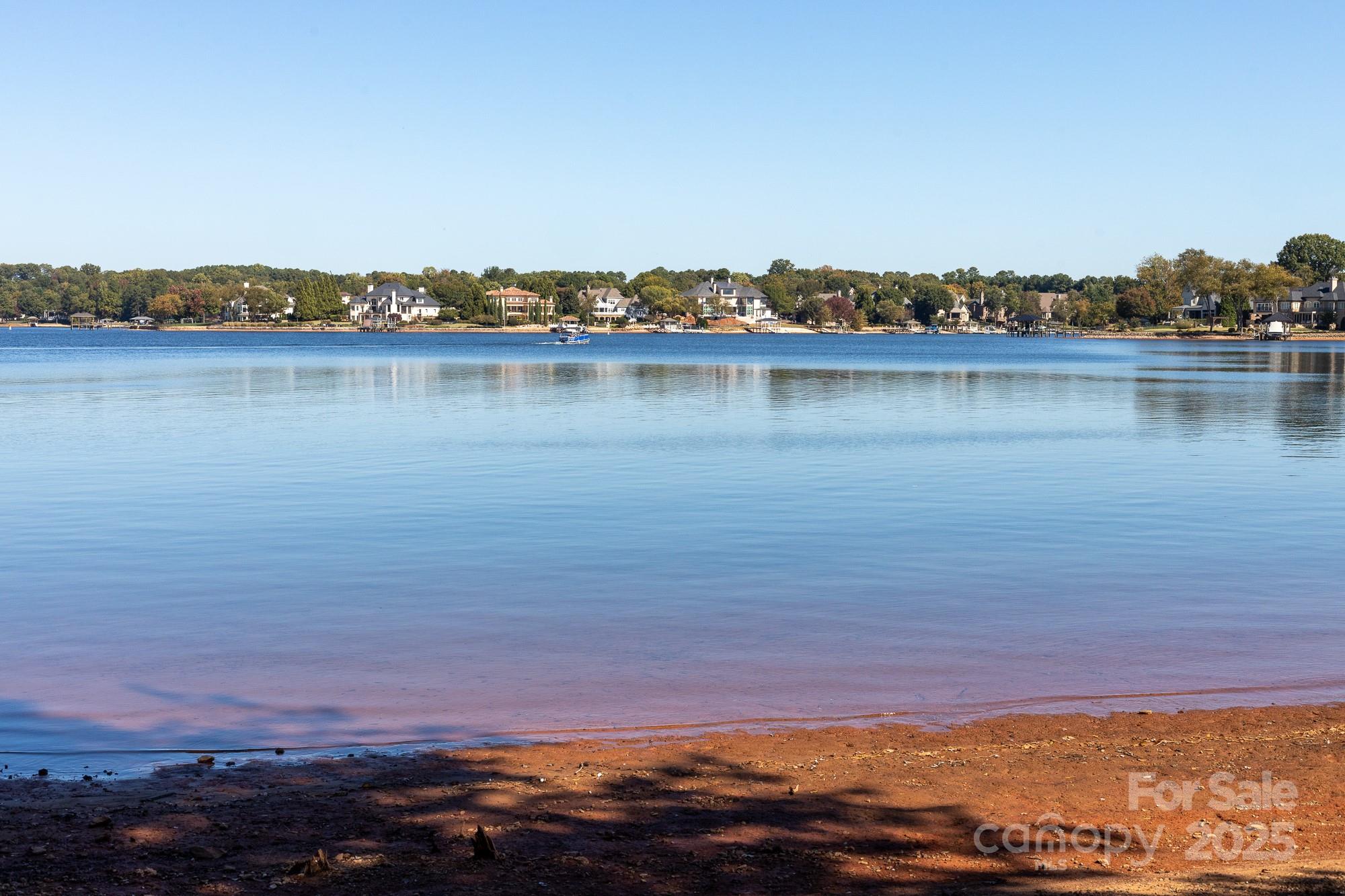 Exceptional Lake Norman Waterfront Opportunity in The Peninsula Area.

Nestled along the prestigious Jetton Rd on Belle Isle, this remarkable waterfront property offers a rare chance to own over an acre of mature, wooded landscape surrounded by some of Lake Norman’s most distinguished estates. With expansive shoreline, tranquil water views, and a private dock featuring a covered boat lift and floating section, this setting perfectly blends natural beauty with prime location.

The existing cottage is impeccably maintained and provides a charming lakeside retreat while plans are envisioned for a future custom residence. A private boat ramp adds to the property’s exceptional functionality, while the dock’s placement along the far-left elevation ensures unobstructed panoramic lake views from both the current home and any future build.

Opportunities of this caliber are seldom available—ideal for those seeking to create a signature lakefront estate in one of Cornelius’s most sought-after locations. One of the last remaining premier waterfront parcels with long-range views—an extraordinary offering in every sense.