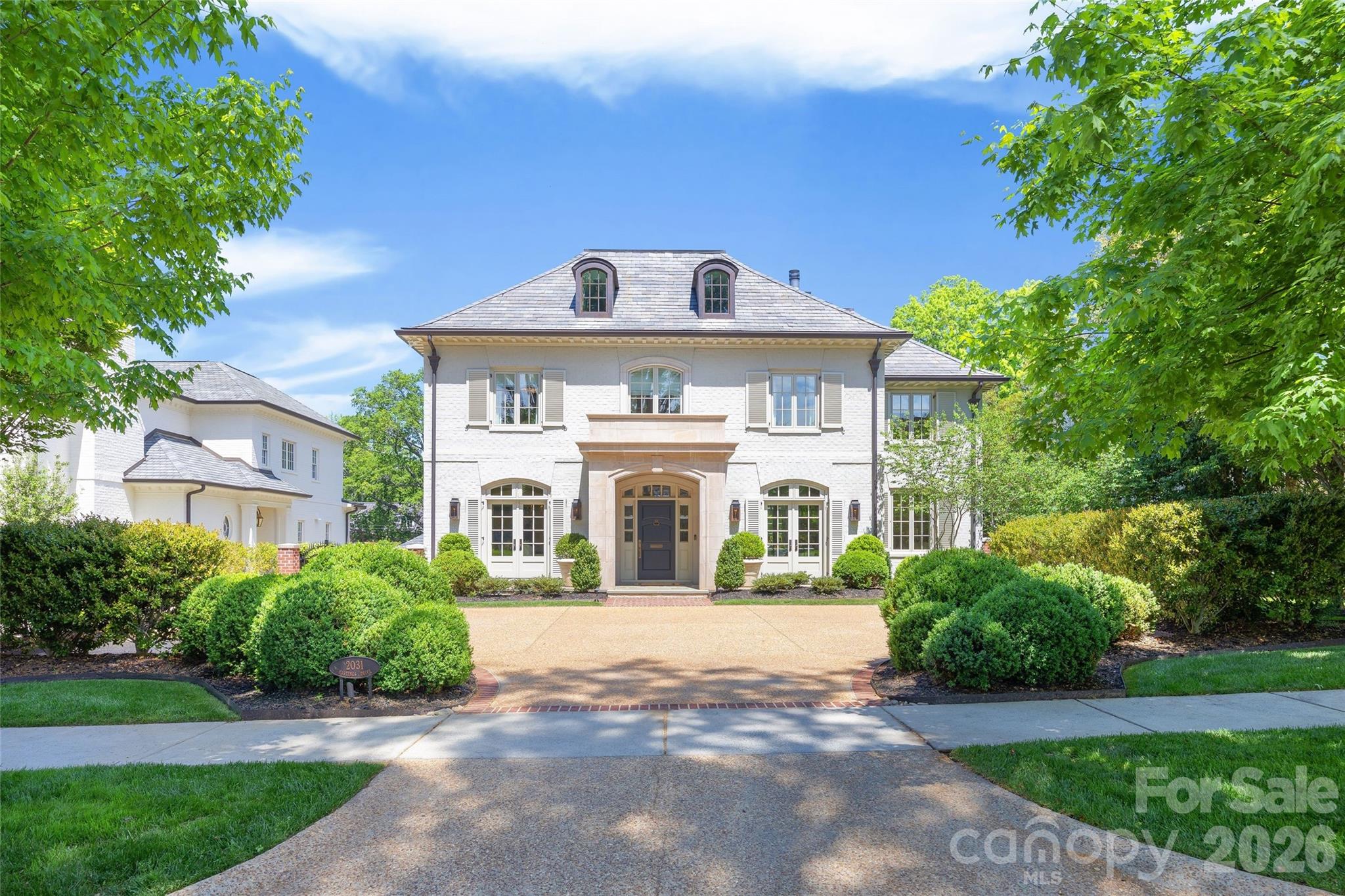 LUXURY LIVING IN MYERS PARK!  This custom residence, designed by Don Duffy and built by Gerrard Builders, is a seamless blend of sophistication and modern luxury.  Sun-filled interiors and soaring ceilings create an airy, refined backdrop, while a thoughtfully designed floorplan offers effortless flow for both entertaining and everyday living.  At the heart of the home, a showpiece chef’s kitchen features an oversized island, walk-in pantry, and opens seamlessly to the breakfast area, bar, and fireside family room.  The main level also offers a private guest suite with full bath, an inviting living room, formal dining room, and powder room.  Upstairs, the expansive primary suite is a true retreat, complete with a spa-like bath with soaking tub, oversized shower, and generous walk-in closet.  Three additional bedrooms, two full baths, a dedicated office, and laundry complete the second level.  The third floor offers a versatile sixth bedroom or bonus space with a full bath.  Outdoor living is equally impressive, with a covered porch featuring heaters and a fireplace overlooking a beautifully designed pool with an electric cover.  A terraced yard with a ramp for easy access and raised garden beds adds both function and charm, all surrounded by lush landscaping.  Additional highlights include a two-car garage, fenced backyard, abundant walk-out attic storage, and a prime location just minutes from the shops and restaurants of Myers Park, with easy access to Uptown.