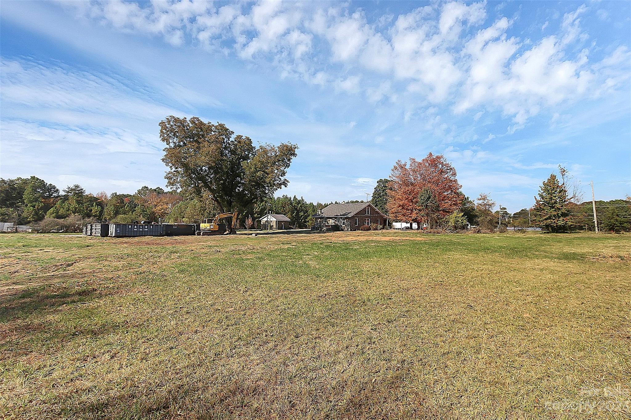 Extremely rare find next to I77 off exit 77. Great location and nearly 5 acres of cleared, level industrial land. All kinds of business opportunities with planning and zoning approval. There is currently an old residential structure in place with septic and well. Can potentially keep as an office or develop land to suit other needs. Water available through City of Rock Hill, requires property to be annexed. Storage yard possible with zoning change and necessary approvals. Updated survey available. Schedule a tour to walk the property.