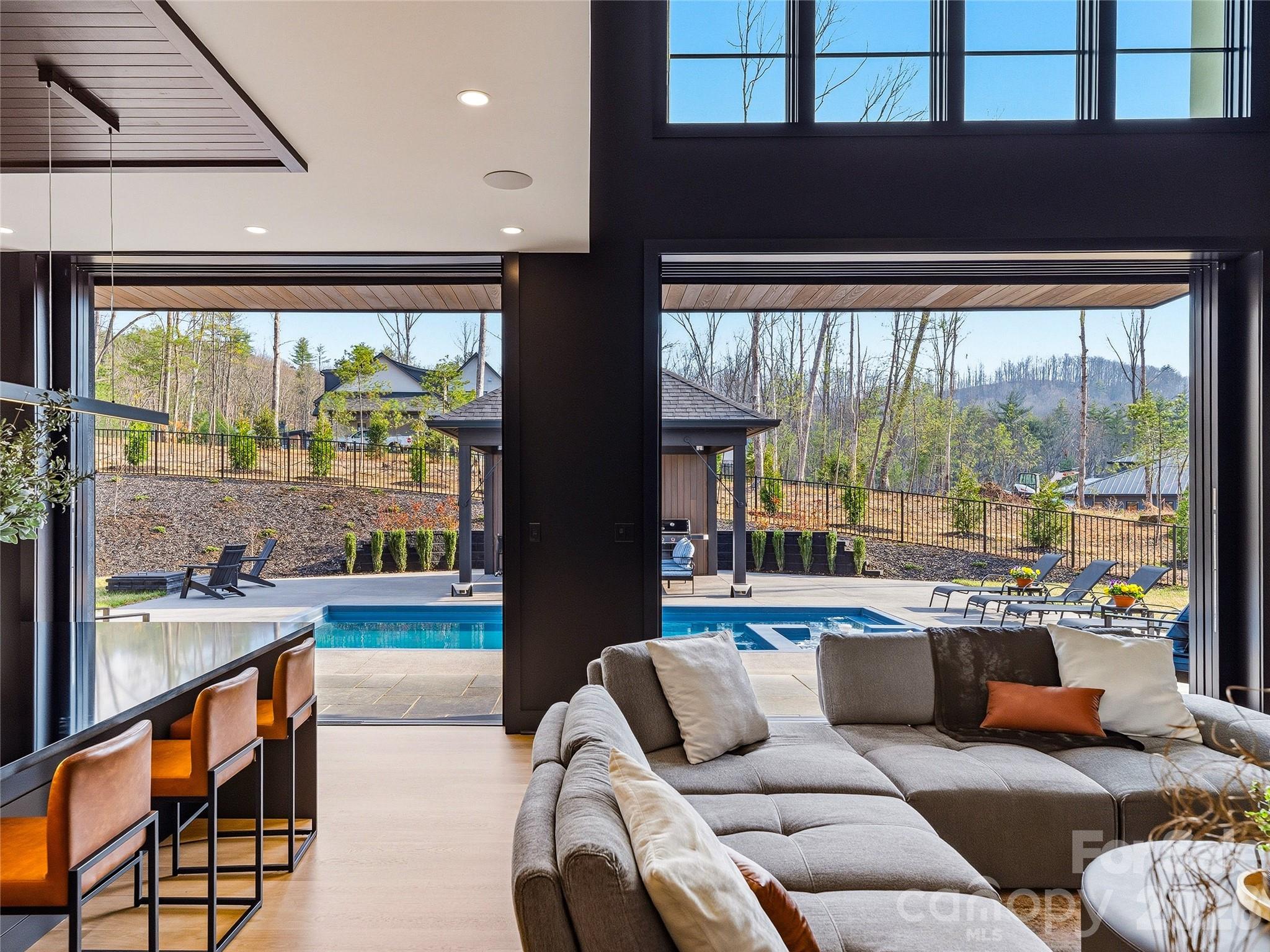An Architectural Statement in Refined Modern Living 
| Offered at $4,432,500 | Fully Furnished | 
Rarely does a residence so effortlessly balance bold design with an unmistakable sense of ease. This newly modern masterpiece — presented fully furnished and move-in ready — is an invitation to live beautifully from the moment you arrive.
Spanning nearly 5,000 square feet of thoughtfully curated space, the open floorplan flows with an effortless logic that is the hallmark of truly exceptional architecture. The main living areas were conceived for the art of gathering — generous in scale, yet intimate in atmosphere — equally suited to an elegant dinner party or a relaxed Sunday morning with family.
At the heart of the home, a custom-crafted modern staircase commands attention as a sculptural centerpiece, representing a singular investment of over $100,000 and serving as a daily reminder that every detail here was deliberate. The furniture collection, hand-selected to complement the home's modern aesthetic, eliminates the years typically spent assembling a cohesive interior — here, the vision is already complete.
The primary suite is a sanctuary unto itself, designed with a singular purpose: to restore. Upstairs, the upper level reveals a thoughtfully appointed world of its own. A second master suite is possible, offering an extraordinary degree of flexibility — whether for multigenerational living, a long-term guest, or a private retreat. Two additional bedroom suites, each with its own private bath, provide refined comfort for family or visitors, while a dedicated game room adds a layer of leisure and entertainment that elevates everyday living well beyond the ordinary.
For those who take their wellness seriously, a state-of-the-art private gym with a dramatic hydraulic folding door delivers a club-level experience without leaving the estate. Outside, an expansive lot provides sweeping lawn space for recreation or formal gardening, while a privately fenced saltwater pool, spa and outdoor living pavilion offers the ultimate in leisure and discretion.
This is not simply a home. It is a lifestyle, fully realized and ready to be lived.
Private showings available by appointment.