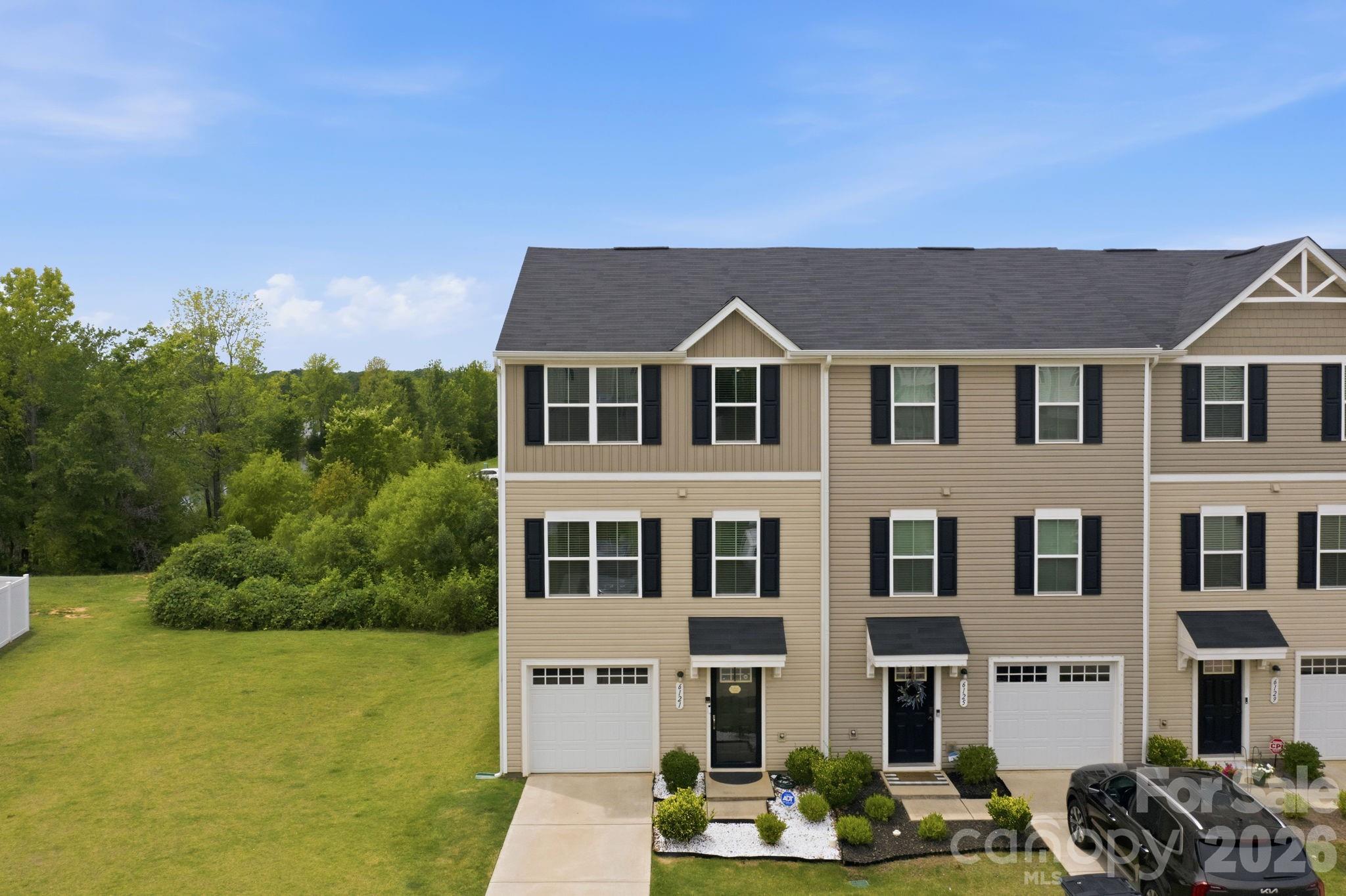 Built in 2021, this beautifully maintained 3-story end-unit townhome offers the perfect blend of style, functionality, and location. Nestled beside green space, this desirable end unit is filled with abundant natural light from both the front and rear, creating a bright and welcoming atmosphere throughout.

Featuring 3 bedrooms, 2.5 bathrooms, and a thoughtfully designed floor plan, this home includes a versatile lower-level flex space that can easily serve as a home office, fitness room, media room, playroom, or whatever best fits your lifestyle. Fresh interior paint, upgraded lighting throughout, durable flooring, and a custom closet system in the primary suite add both style and function. Carpet is limited to the third level, while the main living areas offer a clean, modern aesthetic that's both stylish and easy to maintain.

Step outside to enjoy your private, fenced backyard and patio—perfect for entertaining, relaxing, gardening, or giving pets a secure place to play.

Location is everything, and this home delivers. Just 2 miles from Camp North End and Uptown Charlotte, you'll enjoy quick access to some of the city's best restaurants, breweries, entertainment, and major employment hubs. Commuting is effortless with convenient access to I-77 and I-85, making it easy to get anywhere in the Charlotte metro area.

Whether you're searching for low-maintenance living, modern upgrades, or an incredible location close to the heart of the city, this move-in-ready townhome is one you won't want to miss.