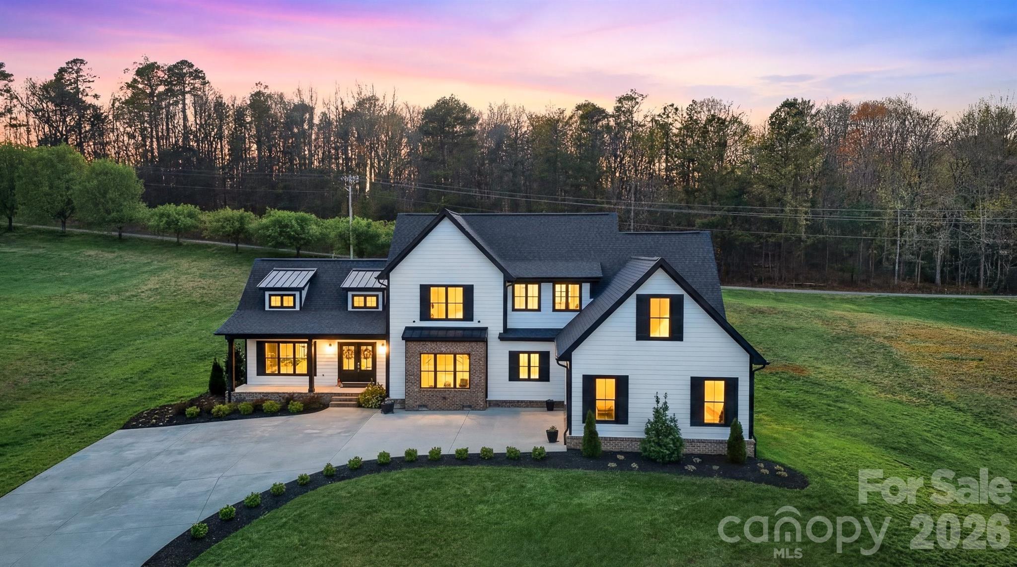 Price Improvement! This stunning 2022 modern farmhouse in Wittenburg Landing is filled with thoughtful design, upscale finishes, and all the bells and whistles to impress even the most discerning buyer. A charming covered front porch welcomes you into a breathtaking great room featuring soaring cathedral ceilings and a dramatic floor-to-ceiling fireplace mantel with electric insert, creating a warm yet sophisticated focal point. Throughout the home, you'll find beautiful wide-plank rustic but elegant farmhouse flooring, adding timeless character, warmth, and style to every space.

The open-concept layout captures views of both the front and back yards and flows seamlessly to the rear patio—perfect for relaxing or entertaining. The kitchen is the heart of the home, showcasing a massive center island, gas range with pot filler, open display shelving, custom cabinetry, and a spacious formal dining area just steps away. 

Tucked down a private hallway, the primary suite offers a true retreat with a soaking tub, tiled shower, double vanity, and an expansive walk-in closet. Just beyond, you’ll find an exceptional laundry room designed to make everyday living effortless, beautifully appointed with ample workspace and conveniently located off both the main hallway and the primary closet, making laundry feel less like a chore and more like a thoughtfully designed part of the home. 

The main level is completed by a double garage, mudroom, and half bath for everyday functionality. 

Upstairs, a loft-style den provides additional living space along with three generous bedrooms, each with private bath access, ideal for family or guests. 

Outside, professionally landscaped grounds sit on a generous 0.86-acre lot within a sought-after waterfront community, just 2 minutes from Taylorsville Beach. Enjoy the perfect balance of peaceful lakeside living and everyday convenience. Located just 15 minutes from Hickory, this home offers quick access to shopping, dining, healthcare, entertainment, and major employers. Commuters will appreciate the easy access to Hwy 16, I-40, Viewmont, Hwy 127, Statesville, and Charlotte, making it an ideal location for those seeking both tranquility and connectivity.

Whether you're searching for a luxury farmhouse near Hickory, spacious family home, or a move-in ready home in Alexander County, this exceptional property checks every box. Come experience the lifestyle, craftsmanship, and convenience that make this home truly one of a kind.
