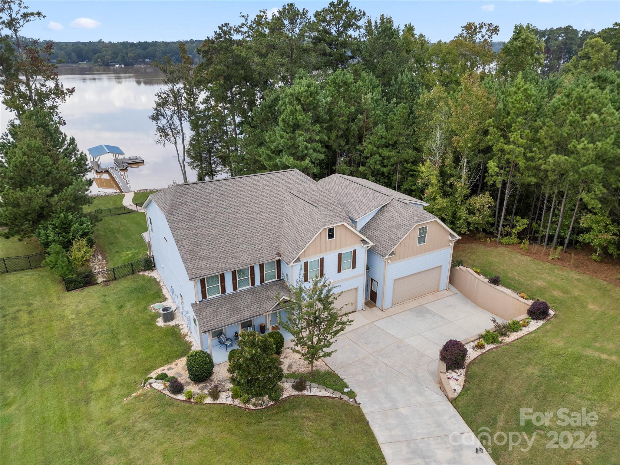 Priced below recent appraisal. With two full baths, a primary suite & living area that includes a gourmet kitchen w/ air fry and convection ovens as well as drawer base cabinets and full overlay, soft close custom cabinetry located on the main floor.  The first floor egresses are all level with no steps & connected via concrete walkways.  The second floor offers a secondary kitchen with french door fridge and dishwasher as well as a loft with covered deck access & 4 bedrooms as well as 3 full bathrooms. Interior walls of bedrooms and bathrooms are insulated for noise cancellation.  Above the garage, one room is finished & the 2nd 1/2 has wiring, insulation, walls & ceilings ready to expand. Outdoor living space includes a Wahoo Floating dock with a 10' by 24' covered slip as well as a 14'x14' party pad; a paver patio, covered patio and covered deck. 121’ shoreline on Fishing Creek Lake. Resort style amenities in Edgewater Golf & Lakeside Community with low HOA fees. Agent is an owner.