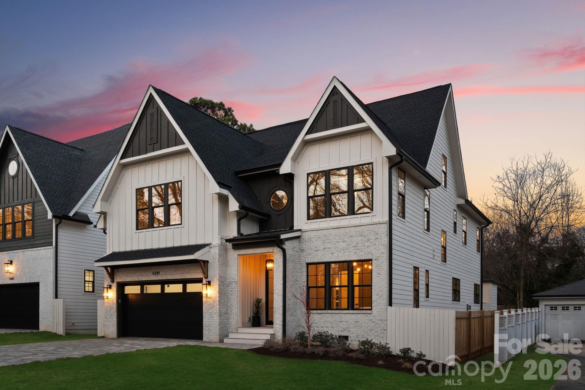 Bold architectural details and expansive living spaces define this exceptional new construction home in the heart of Cotswold, offering 5 bedrooms and 5 full baths across three thoughtfully designed levels. Located along a quiet street surrounded by other newly built residences, the home enjoys a premier location near Cotswold Village, SouthPark, Uptown, Providence Road, and Independence Boulevard, with convenient access to Charlotte’s top-rated public and private schools.

A covered entry and modern glass front door welcome you into a light-filled interior featuring 10-foot ceilings on the main level, red oak hardwood flooring, elegant trim work, and designer lighting throughout. This residence showcases a distinctive color palette that blends warm neutrals with rich accents of color, complemented by striking gold hardware and curated finishes that add depth and personality. Exposed wood beams in the kitchen and living areas introduce architectural character and warmth, creating an elevated yet inviting atmosphere.

The open-concept layout seamlessly connects the kitchen, dining, and living spaces, offering generous scale for both daily living and entertaining. The chef’s kitchen is anchored by an oversized island with seating, floor-to-ceiling soft-close cabinetry, a spacious walk-in pantry, and premium appliances. The adjacent dining area features a built-in buffet area with floating shelves and a beverage/wine fridge. The living room centers around a modern gas fireplace and opens through sliding doors to a fully fenced backyard. A spacious patio with an outdoor fireplace extends the living area outdoors, creating an ideal setting for gathering and year-round enjoyment.

A main-level bedroom with an ensuite bath provides flexibility for guests or a private office. Upstairs, the primary suite overlooks the backyard and features a spa-inspired bath with dual vanities, soaking tub, oversized walk-in shower, and a large custom walk-in closet designed with extensive shelving and abundant hanging space for two. Three additional guest bedrooms, a bonus room to be used as a home office, kid’s playroom, or storage area, and a conveniently located laundry room complete the second level. 

The third level is dedicated to a spacious bonus retreat, complete with a built-in buffet area featuring a wet bar sink and wine and beverage fridge, perfect for entertaining, media, or recreation. Generous proportions, distinctive architectural details, high-quality finishes, and a peaceful Cotswold setting make this home an exceptional opportunity to own one of Charlotte’s finest new construction residences.
The home is deeded in Craigmore Hills but is located in Cotswold.