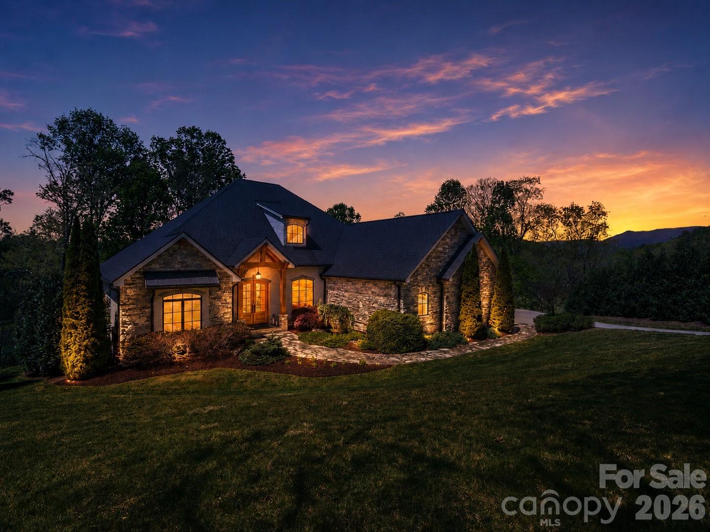 This house is also being sold with adjoining lot under MLS# 4375003. Welcome to luxury mountain living in the gated community of Grand Highlands at Waterford Lakes. Built in 2016, this stunning custom-built home offers 3,054 sq ft of beautifully designed one-level living with 3 bedrooms, 3 full bathrooms, and 1 half bath, blending timeless craftsmanship with modern comfort. Thoughtfully designed for everyday ease and convenience, all primary living spaces are located on the main floor. Situated on beautifully landscaped grounds, this property offers exceptional privacy and an impressive setting. From the moment you arrive, the striking stone and stucco exterior, mature landscaping, and inviting covered entry create unforgettable curb appeal. Inside, soaring 12-foot ceilings in the living room and 11-foot ceilings in the kitchen and dining areas enhance the home’s spacious and elegant feel. The living room is centered around a natural gas fireplace with custom built-ins, while the dedicated office also features beautifully crafted built-in cabinetry. Designed for both entertaining and everyday living, the chef’s kitchen, which was featured in Carolina Home + Garden magazine is equipped with premium Thermador appliances, including a natural gas range and dishwasher, along with a Sub-Zero French door refrigerator. The open-concept layout flows seamlessly into the dining and living spaces, all positioned to take advantage of the peaceful outdoor setting. The expansive back deck serves as an extension of the living space, with access from the primary suite, living room, and dining area. Enjoy relaxing seasonal views overlooking Waterford Lake while surrounded by the serenity of this private mountain community. Additional highlights include a spacious 3-car garage, on-demand hot water system, hot and cold exterior water spigot, partial unfinished basement with approximately 1,100 sq ft and 11-foot ceilings, and quality finishes throughout. The thoughtful floor plan offers generous bedroom suites, abundant storage, and the comfort of effortless one-level living. Conveniently located near Hendersonville and Asheville, this exceptional property offers the perfect combination of luxury, privacy, and mountain charm.