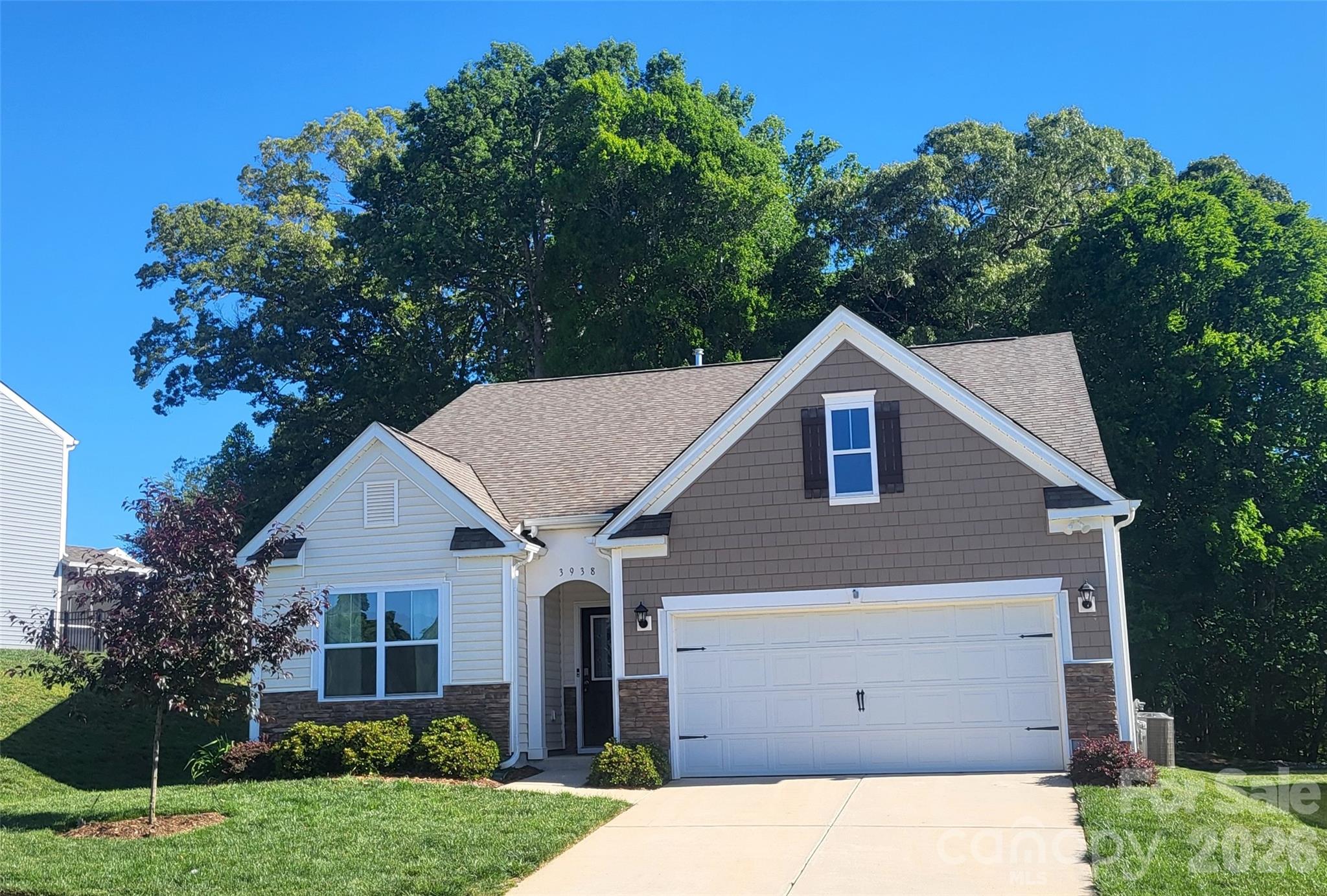 Discover the perfect blend of modern comfort and timeless charm in this move-in-ready, single-level 3 bedroom, 2 bath, 1,651 sq. ft home w/mature trees and an established lawn versus sod!  While not age-restricted, the easy, all-on-one-level layout makes this home a standout choice for anyone seeking comfort, convenience, and low-maintenance living in a USDA eligible community. 

Step outside to a beautifully landscaped, low-maintenance yard with river rock accents and a covered back porch—ideal for morning coffee, bird watching, or winding down in the evening. The wooded backdrop adds a sense of privacy and a peaceful, natural view.  The open-concept kitchen, dining, and living area—with soaring 9-foot ceilings and a cozy GAS LOG fireplace with blower—creates one spacious, connected great room that’s perfect for everyday living and entertaining.  Thoughtfully designed and gently lived in, this one-owner home is loaded with upgrades such as a Deako Smart Switch Lighting Automation Package & premium fixtures beyond the builder's standard lighting offering. Better yet, the washer, dryer, and refrigerator are included. 

Enjoy the charm of small-town living with modern amenities in a community that feels like stepping back in time, with its nostalgic firehouse & elementary school. Enjoy extra wide streets only found in Phase One of the neighborhood.    Every detail is in place so no need to wait for a finished product.  Outdoor lovers will appreciate being just minutes from Lyle Creek Greenway and Riverbend Park for walking, biking, and soaking up nature.Ideal location! In addition to being close to downtown Conover, the home is conveniently located to the ever growing cities of Hickory and Denver.