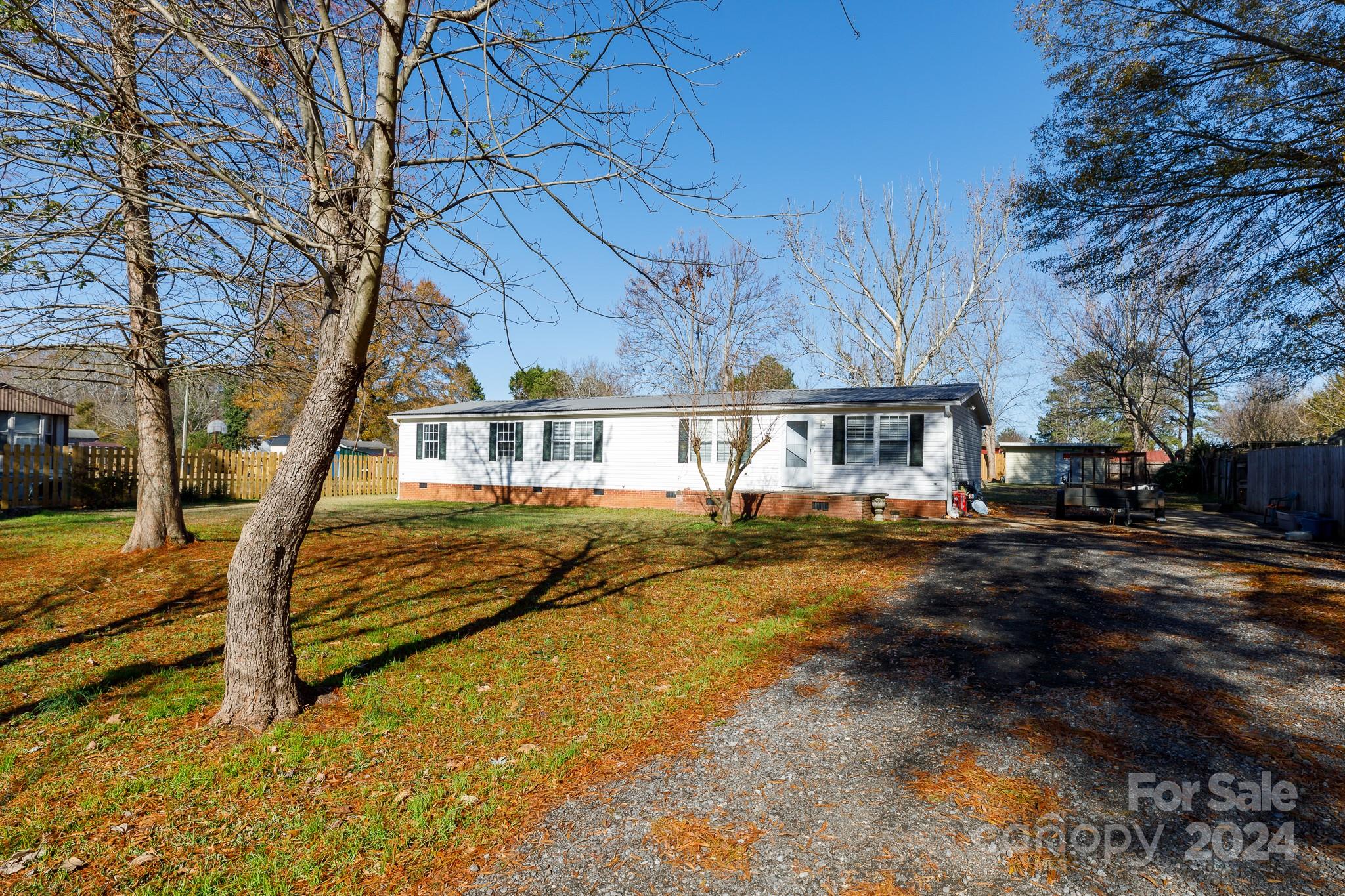 Discover country living in this charming 3-bedroom, 2-bath home, nestled on a spacious 0.57-acre lot. The open floor plan features a well-appointed kitchen with a work island, breakfast bar, and dining area, perfect for gatherings. The primary suite offers a peaceful retreat with dual closets, dual sinks, a large garden tub & a separate shower. Enjoy outdoor living in the level yard with a deck and a convenient storage building. Don't miss this opportunity to make it yours!