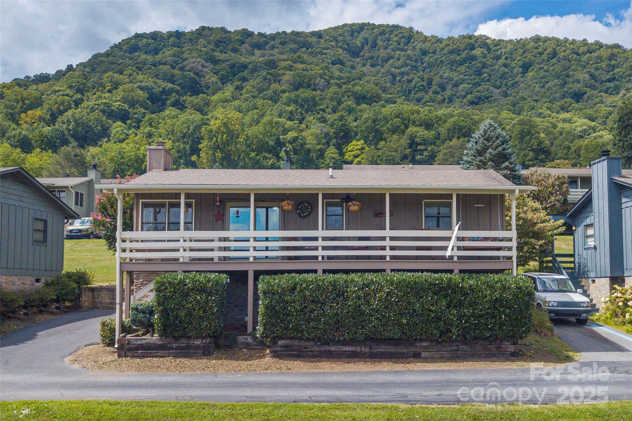 Cozy Mountain View Retreat! Enjoy breathtaking year-round sunrises and sweeping mountain views from the expansive covered front porch of this Maggie Valley home. Featuring an open floor plan with 2 bedrooms and 2 baths, this home is designed for both comfort and nice outdoor space. The stone fireplace with gas logs creates a warm ambiance.  Nice wide Pella sliding glass doors to the front and back covered porches.
The partially finished crawl space offers excellent potential for a workshop or additional storage. Nestled in a pet-friendly neighborhood, this home is ideally located near Maggie Valley, Waynesville, and the Cherokee Reservation.
Some of the upgrades include Corian kitchen countertops, artisan vanities, a walk-in tile shower, and beautiful flooring throughout.
Schedule your showing today and experience mountain living at its finest!