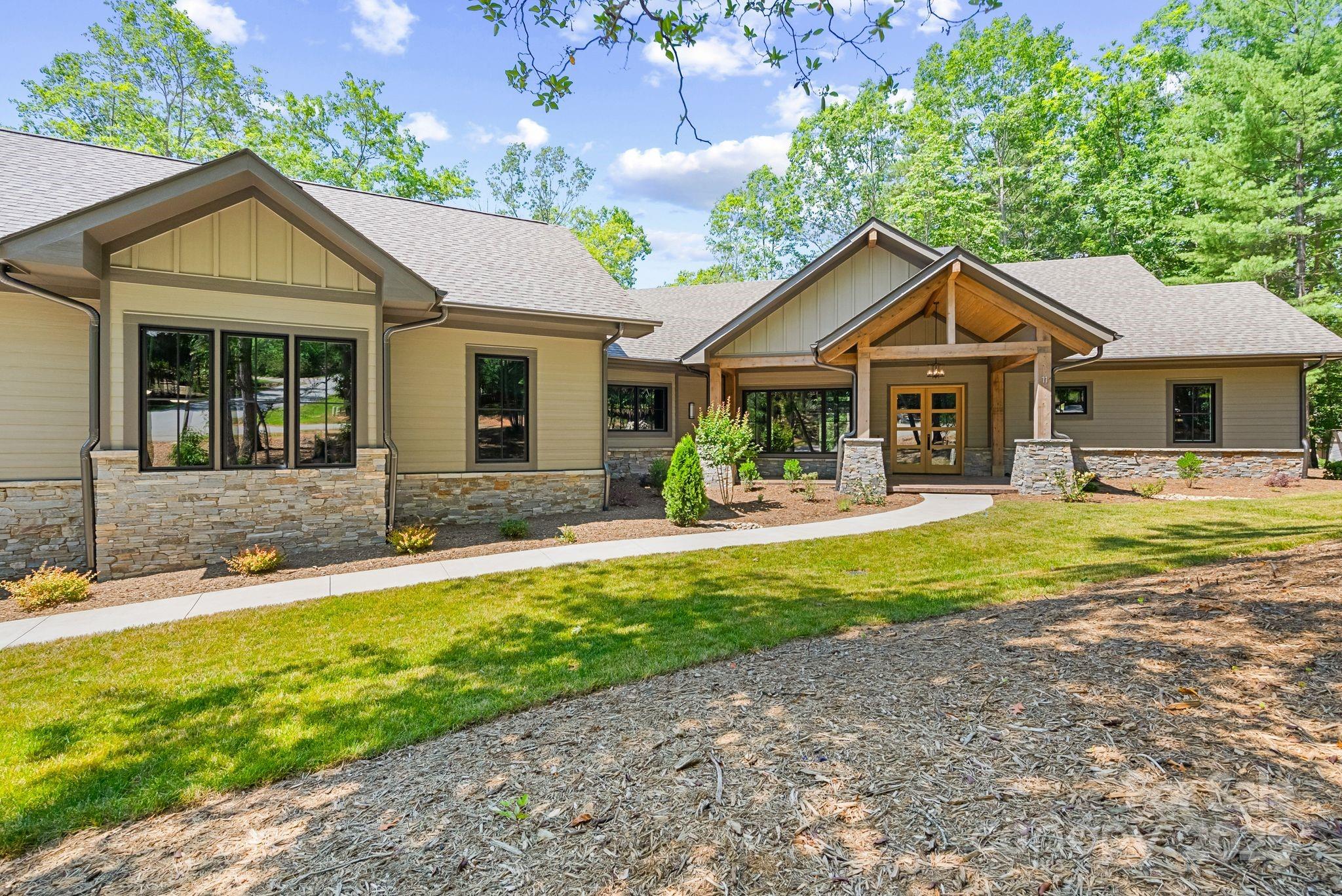 Come home to The Cliffs at Walnut Cove, The Cliffs' fourth gated golf and wellness community located in Asheville, North Carolina. 

This stunning single-story residence offers an open floor plan with expansive living areas, perfect for exceptional entertaining and comfortable living. Inspired by a modern cabin in the woods, the home seamlessly blends with the surrounding natural landscapes. The exterior is characterized by heavy wood lap siding and stone enhancements, complemented by contemporary design elements, creating an aesthetic unique to Walnut Cove.

Exciting new construction from Cliffs Builders is planned to be completed in early 2025, promising even more luxury and refinement in this prestigious community. 

A Club membership at The Cliffs is available for purchase with this property, giving you access to all seven of The Cliffs' communities.