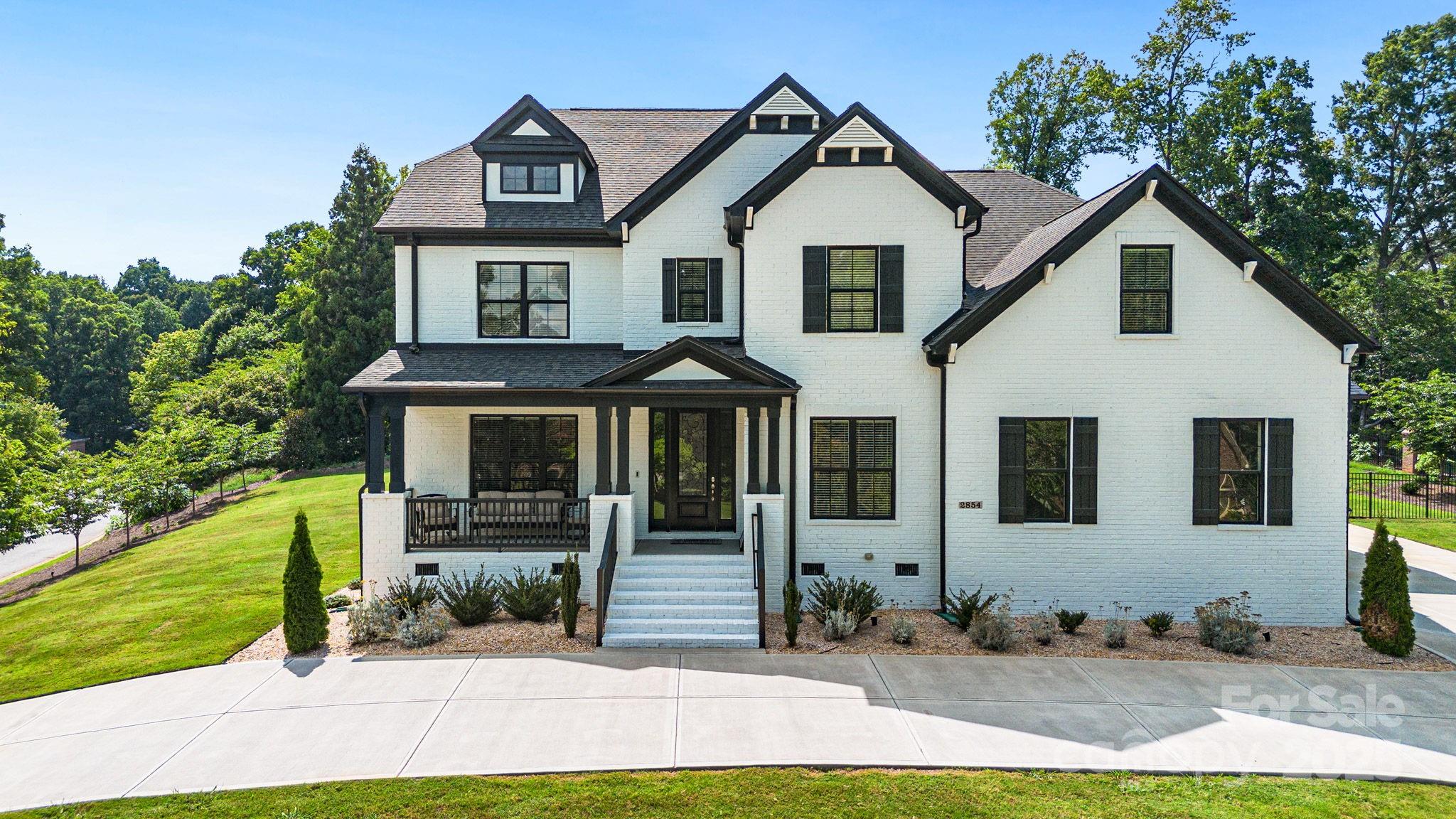 Welcome home! Immaculate luxurious home boasting open floor plan and sparkling in-ground swimming pool, nestled in the heart of one of Rock Hill's most sought-after neighborhoods. Approaching this stunning home, you'll be captivated by its charming curb appeal. The classic facade and a covered front porch welcome you to the home, where sweeping high ceilings and a light-filled interior present spectacular views of the backyard oasis. The heart of the home is the gourmet kitchen, boasting quartz counters, ample cabinetry, a spacious breakfast bar with seating, and top-of-the-line stainless steel appliances. Primary bedroom on the main floor with a luxurious en suite bathroom. The dining and living room is bathed in natural light, thanks to large windows that frame the beautiful outdoor views. Step out to a back porch screened in with glass doors overlooking the pool. Additional features of the home include a recreational room, a bonus room, and a three-car garage with a circular drive.