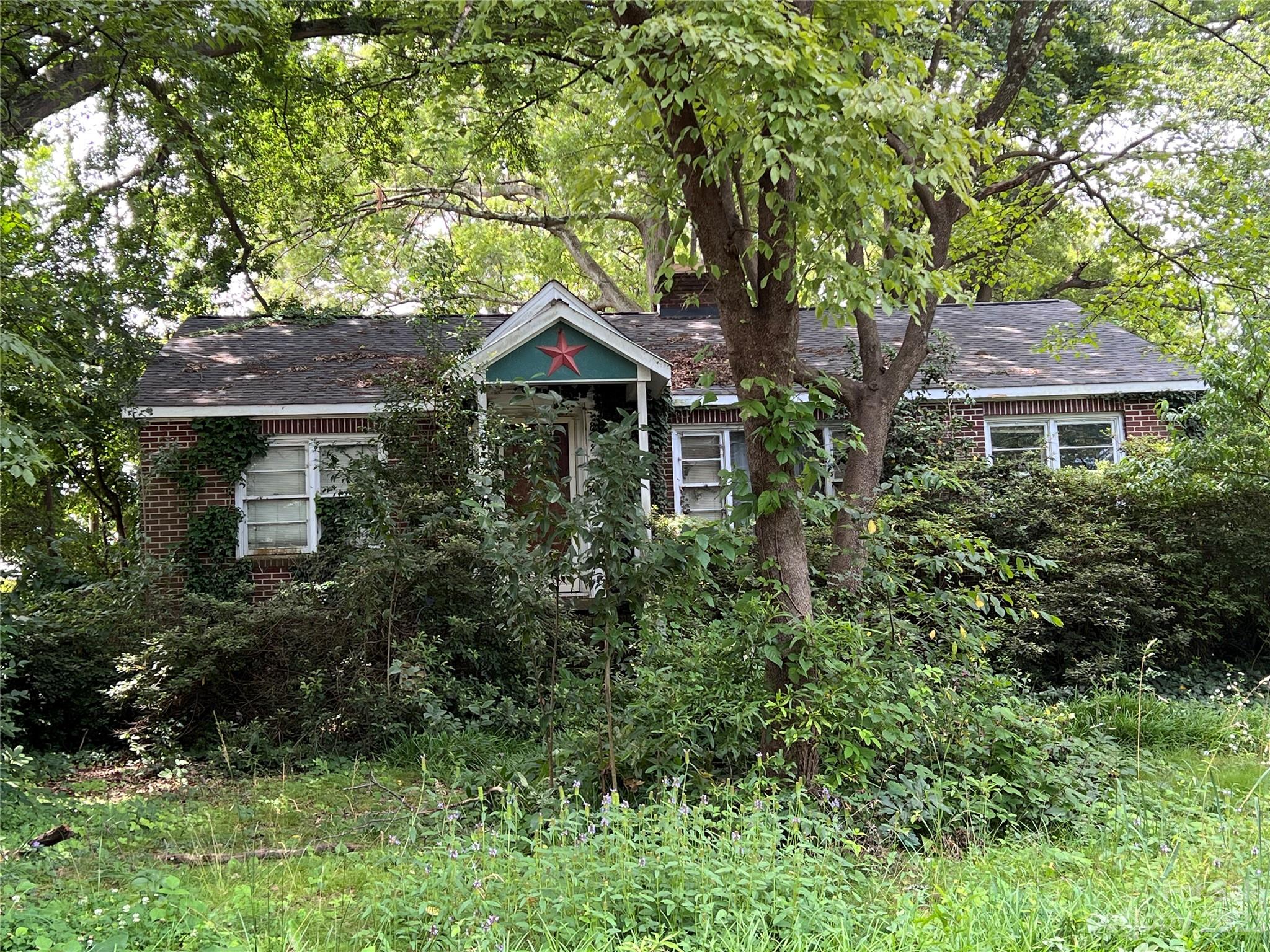 Great property ready for rehab/remodel! New roof in 2021. Large lot. Brick home with original hardwoods. Classic 50's ranch with boho artisan décor ready for your touch. Main bath & half bath were updated several years ago. Original electrical panel from 1957. Soffits, fascia & trim need some work. A few windows need to be replaced. Gas fireplace sold as-is. House needs updating and new appliances. Huge back yard. Plenty of space to park an RV, camper or boat. So much potential waiting for you! AS-IS sale. Easy access to 77 & downtown Rock Hill from Dave Lyle Blvd. No sign in yard. Please do not disturb owners.
