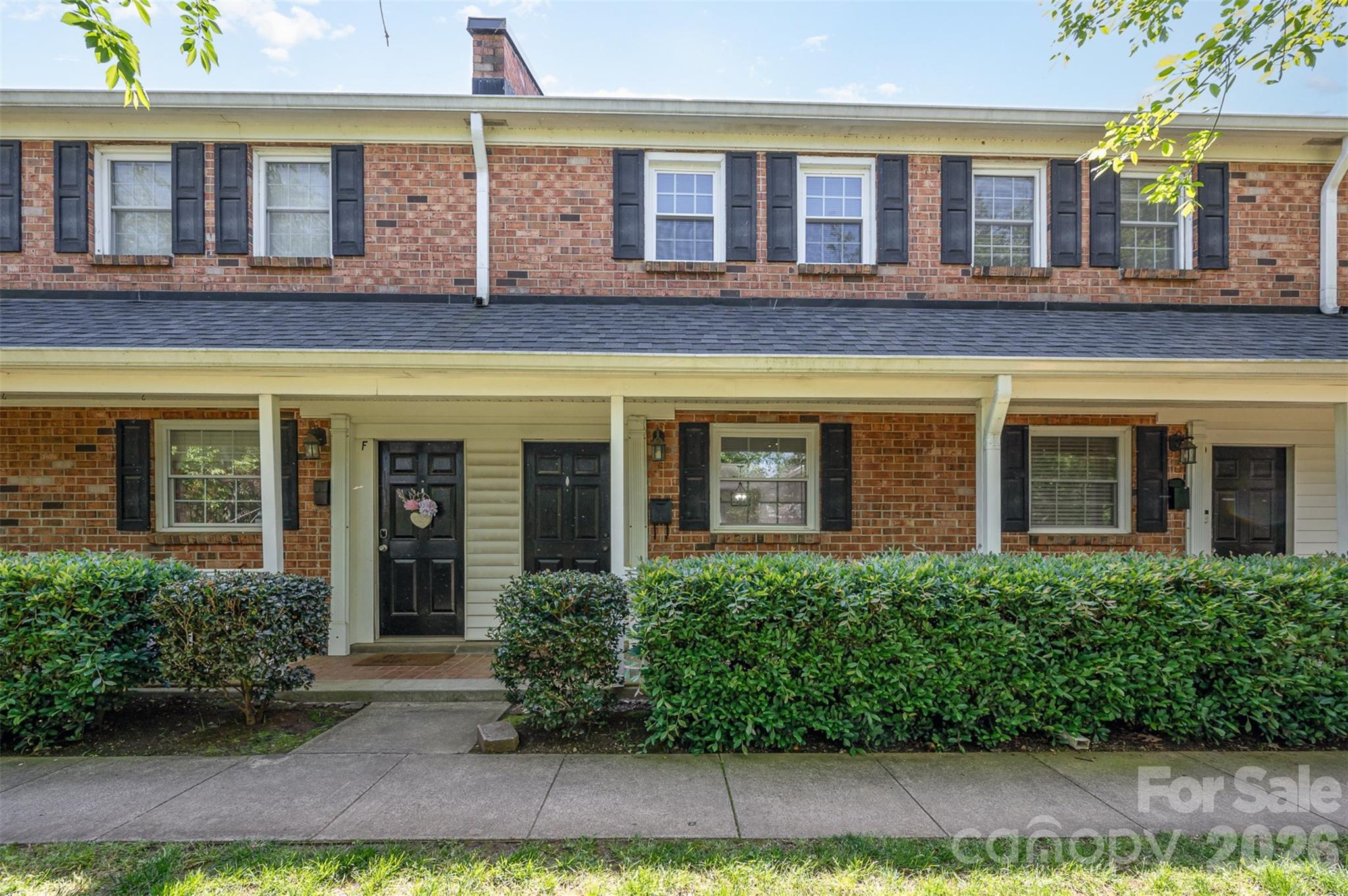 PRICED TO SELL!! Updated condo walking distance to Plaza Midwood!! This beautifully updated 2-bedroom, 1.5-bath condo lives like a townhome and offers modern comfort with classic charm in an unbeatable location. Step inside to discover refinished hardwood floors throughout the main level, leading you to a stunning exposed brick accent wall and gas fireplace in the living room. The updated kitchen features granite countertops, a sleek subway tile backsplash, and floating shelves for a modern, charming feel. This home has been thoughtfully upgraded with a tankless water heater (installed 2022), new washer and dryer (2023), new windows (in kitchen and bedrooms 2023), new toilets (2023), new blinds (2024), and new concrete poured for the back patio (2024). Just minutes from the vibrant energy of Plaza Midwood and Uptown Charlotte, this home blends convenience with character. Don’t miss your chance to own this move-in ready gem in a highly sought-after location!