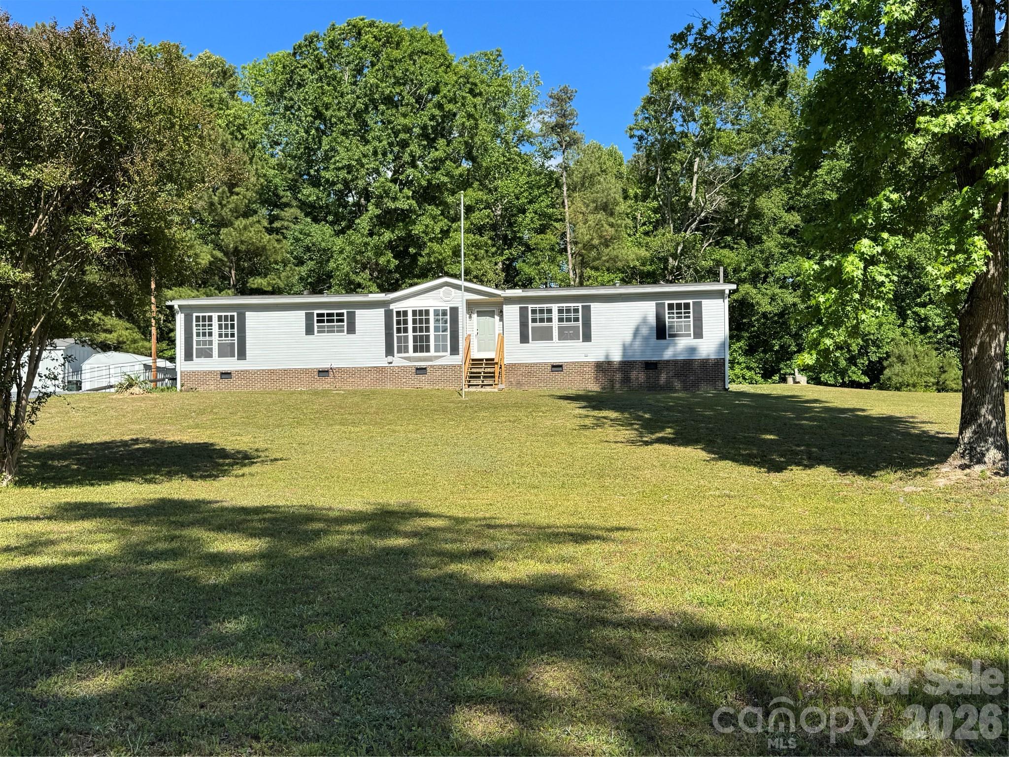 Modern updates meet prime location! This stunning home, 2BR/2BA with bonus room which includes a closet sits in close proximity to Lake Tillery and Uwharrie National Forest—perfect for boaters, hikers, and nature enthusiast.  This beautifully updated kitchen features quartz countertops, an oversized island, tile backsplash, and new cabinets equipped with soft-close drawers and under-cabinet lighting. Throughout the home, you will find modern finishes including waterproof laminate flooring, recessed lighting, ceiling fans, and smooth ceilings, with the popcorn ceiling removed everywhere (except the laundry/mudroom.) The primary bathroom serves as a private retreat with its jetted tub, tile walk-in shower, and illuminated mirror, while the guest bath is elegantly finished with tile and glass doors.  Additional features include a whole-house generator for uninterrupted power, convenient outbuildings perfect for tools, toys, or workshop.