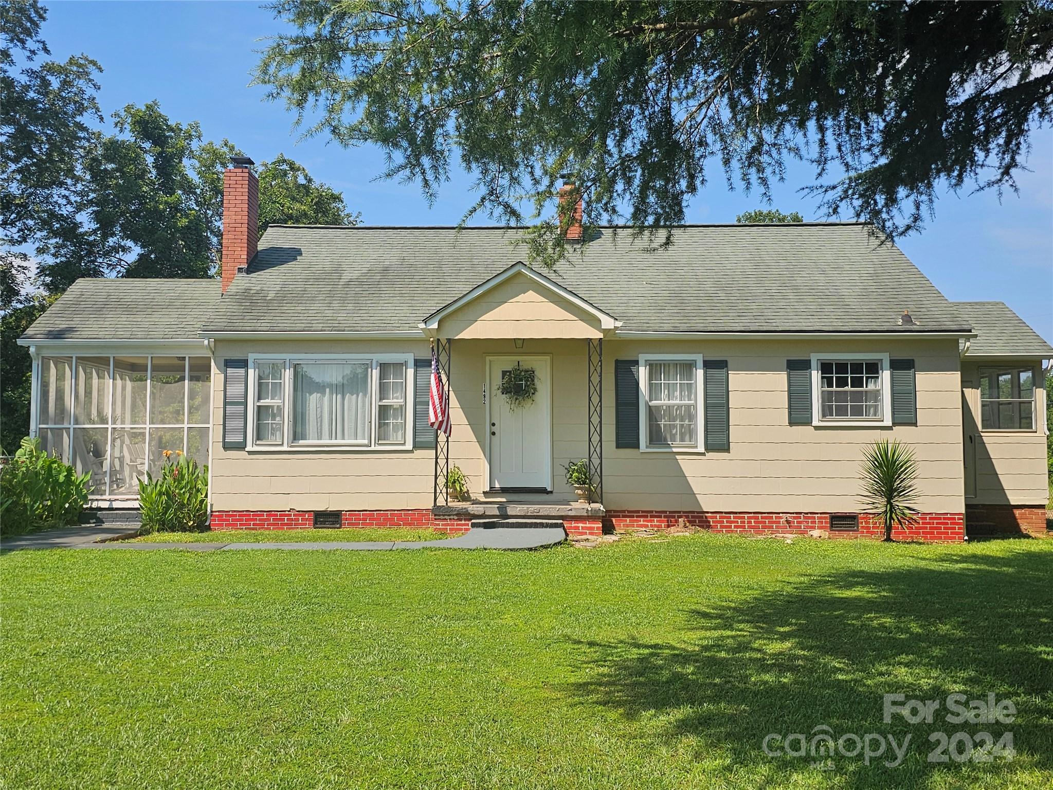 Beautiful solid older home with a combined living room and dining to give that open feel. In the living room there is a fireplace with an antique hearth and modern ceiling fan. Living room and dining , hallway and bedrooms have the wooden floors that are in a rich finish. Lots of windows throughout that makes the interior bright. The kitchen has custom wooden cabinets with tile flooring. Updated range and refrigerator remains. The 2 bedrooms are spacious. Primary bedroom has a ceiling fan as well. The bathroom was just revamped a week ago. Updated vanity, new flooring , new tub, enclosure and fixtures . So clean and fresh. Exterior,  there is a screen-in porch that will make a relaxing space at the end of any day. The place is totally fenced and has a cement drive.