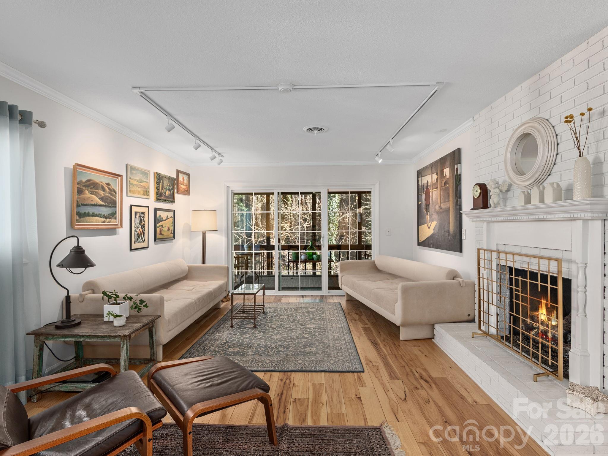 Motivated Seller. All reasonable offers considered. Perfectly redesigned, this very special condo will appeal to anyone who likes an open floorplan and meticulous attention to detail. A split bedroom plan provides privacy plus updated bathrooms in each suite. The floors are all hard surface, tastefully installed with light wood or matching contemporary tile. The gourmet kitchen features pullout shelves and pantry, soft pull drawers and a console along one wall for extra storage and entertaining. Whirlpool Gold series appliances were chosen. Relaxing large screened-in back porch. Close to the forest and away from the street you can’t help but relax. A separate deeded garage offers plenty of additional storage and a safe place for your vehicle out of the weather. This home is conveniently located less than 2 miles from historic downtown Hendersonville, Pardee Hospital and major roadways. Don’t miss out on an a beautiful, affordable home in the fast growing community of Hendersonville.