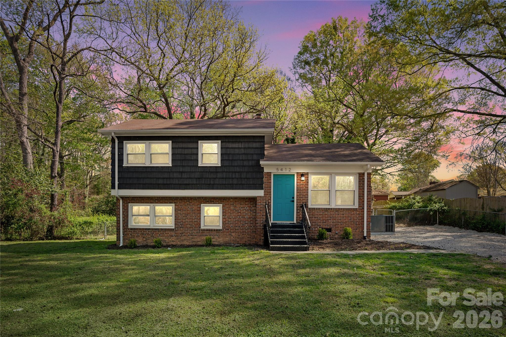 Freshly updated and move-in ready, 5412 Millhaven Lane offers the perfect combination of modern updates, flexible living space, and a convenient Charlotte location—all with no HOA.

Inside, you'll find fresh paint, replacement windows, beautifully updated kitchen and bathrooms, and a bright, welcoming floor plan designed for everyday living. The kitchen is complete with brand-new appliances, including the refrigerator, while the new washer and dryer are also included. A new HVAC system provides peace of mind from day one.

With four bedrooms split between two levels, the layout offers incredible flexibility for guests, a home office, playroom, or workout space. Step outside to enjoy the spacious, fully fenced backyard—ideal for entertaining, pets, gardening, or simply relaxing in your own private retreat.

Located just minutes from Uptown Charlotte, shopping, dining, parks, and major highways, this home offers the convenience of city living with the freedom of no HOA.

Qualified buyers may be eligible for up to $10,000 in lender credits plus 100% financing with no PMI through the preferred lender. Contact the listing agent for details.