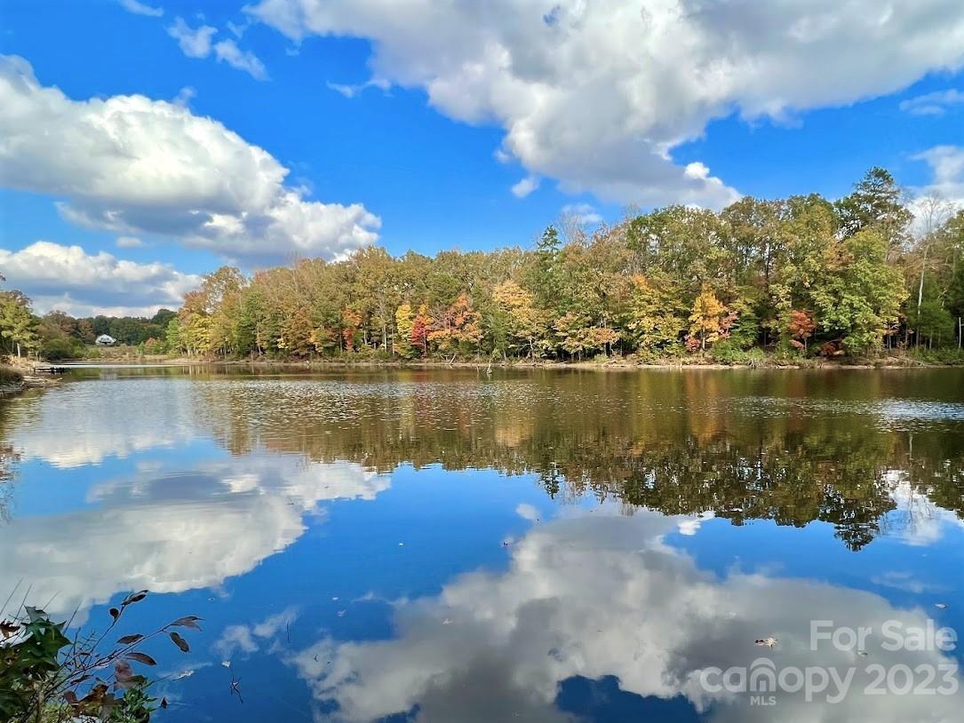 Three Lakes Preserve Lot 3B ~ Escape to nature and build your dream home or equestrian estate on this 10.18-acre wooded and waterfront lot in Three Lakes Preserve. Enjoy the serene views of a magnificent 5-acre pond, perfect for kayaking and fishing. Ideal for nature enthusiasts seeking peace and privacy, this beautiful property is located in a new gated development that includes a limited number of large-acreage waterfront lots. With over a mile of community trails featuring scenic views of two large ponds, there are plenty of opportunities for walking, biking, and horseback riding. All located just 10 minutes south of the charming and lively downtown Waxhaw! Bring your custom builder or inquire about our recommendations.  *Also consider Lot 3A (MLS# 4000561) - the adjacent 10.17-acre waterfront lot that can be combined with Lot 3A to provide additional space and shoreline.