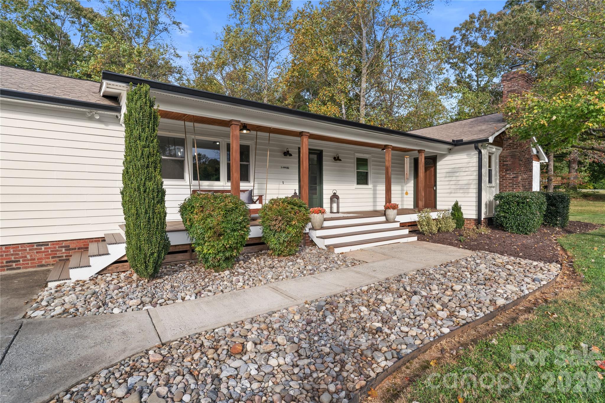 Welcome to this stunning modern farmhouse offering the perfect blend of charm, comfort, and functionality, all on one level and nestled on 1.25 private acres surrounded by mature trees. Thoughtfully designed with both everyday living and entertaining in mind, this home offers spacious rooms, beautiful finishes, and a warm inviting feel throughout. Just off the kitchen, you’ll find a spacious family room along with a gorgeous dining room surrounded by windows, creating the perfect setting for gatherings and holiday dinners. The flexible floor plan includes 3 bedrooms, 4 full bathrooms, plus 2 additional rooms with closets that could easily be used as guest rooms, playrooms, a home gym, or hobby spaces. There is also a dedicated office, ideal for working from home or creating a quiet retreat. Step outside and enjoy peaceful mornings on the covered front porch or relax in the evenings on the covered back porch overlooking the private backyard and wooded backdrop. The level backyard offers plenty of usable space and is ideal for a future pool, outdoor entertaining area, or creating your own private backyard oasis. The property also includes a storage shed for lawn equipment, tools, or hobbies.