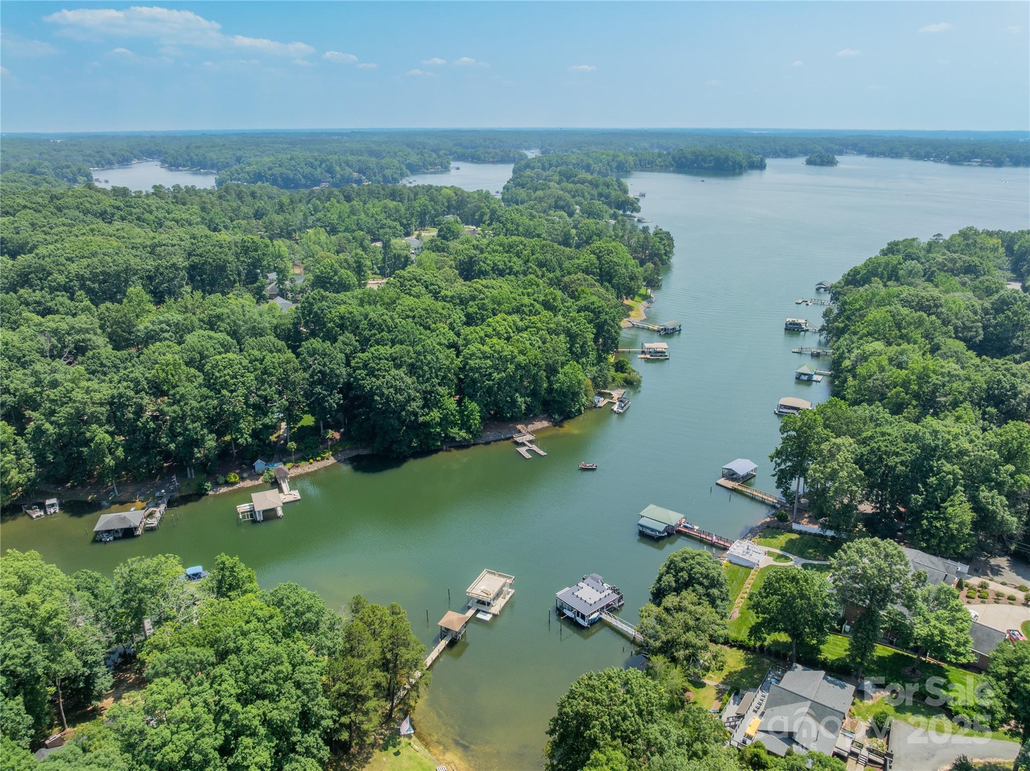 This beautifully wooded waterfront lot on Lake Norman is ideal for your dream home. The 0.66-acre lot, located on a deep cove with easy main channel access, has no HOA, allowing you to build freely among exquisite homes. It features a large existing dock and a concrete boat ramp. Your perfect waterfront lot awaits!