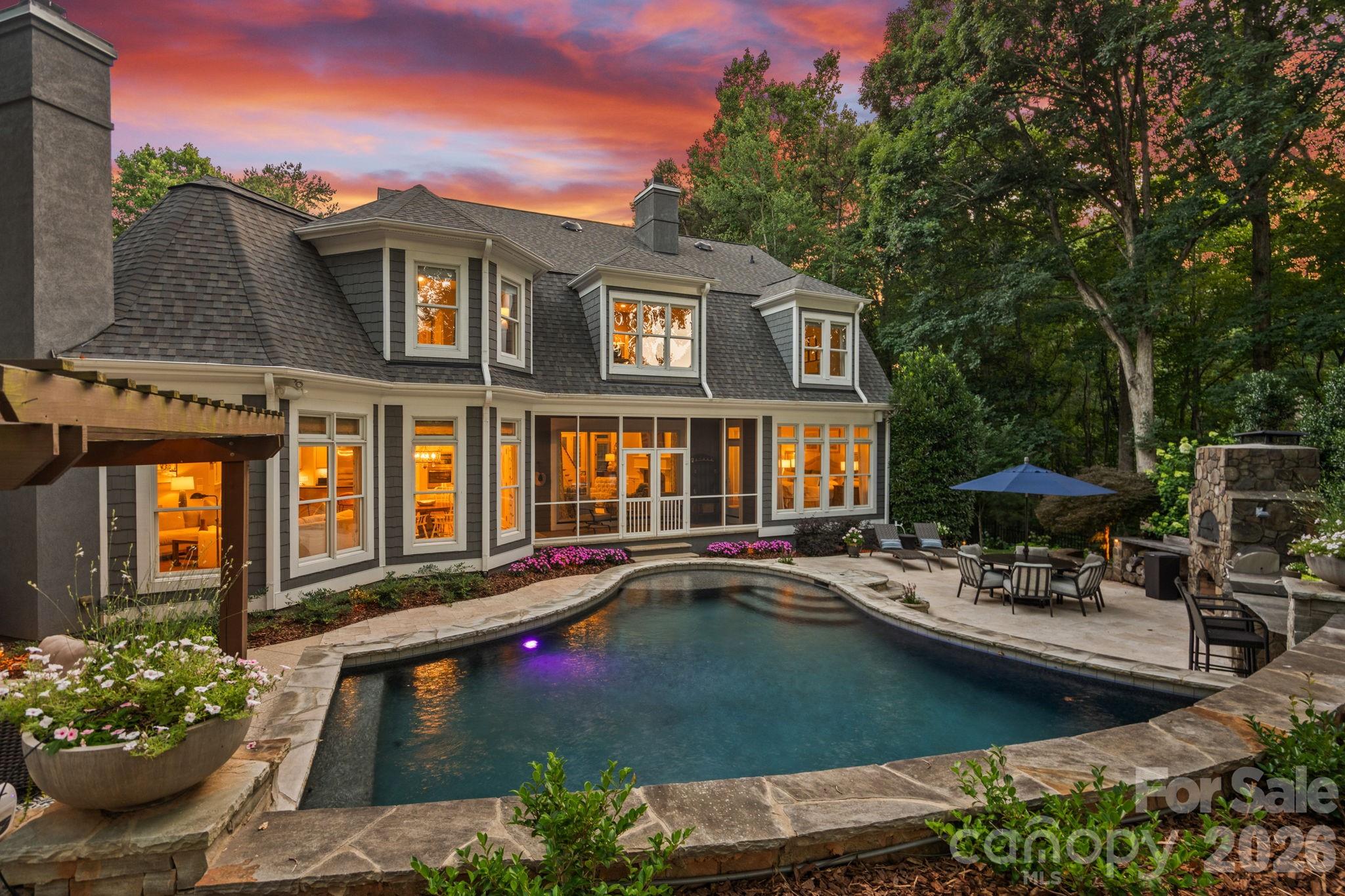 Welcome to this beautifully reimagined Cape Cod on the 2nd fairway of Trump National Charlotte.  Perfectly situated on nearly 1.5 acres offering privacy and natural beauty, this completely renovated, move-in ready home offers timeless architecture with elevated, modern updates throughout.  Every inch reflects exceptional craftsmanship, from the soaring 20-foot foyer to the extensive custom molding carried through every room.
The chef's kitchen features custom cabinetry and a luxury appliance package, including a Sub-Zero refrigerator, Wolf Gas Cooktop and Cove dishwasher.  A scullery with custom cabinetry, shiplap, and quartz counters adds everyday function.  The primary suite offers a true retreat with a recently updated spa-inspired bath all overlooking the private backyard oasis.  Thoughtfully designed living spaces include 3 ensuite bedrooms – one considered a secondary primary, media room, and game room with a wet bar and tongue-and-groove shiplap detailing.

Step outside to a resort-style backyard designed by Downey & Associates, anchored by a saltwater pool and a travertine pool deck. Entertain year-round with the outdoor kitchen (built-in grill, sink, storage, and beverage center), flagstone gas fireplace, pizza oven, pergola, and a standalone fire pit with seating. A tiled, screened porch with a tongue-and-groove ceiling offers the perfect spot to enjoy the fairway views.

Additional peace of mind comes from a whole-home generator, whole-house water filtration system, and new roof (2025) — thoughtful upgrades layered beneath every high-end finish.

Ideally located in The Point, this home offers close access to your boat slip at Pier W, with ample golf cart parking, putting the very best of the Trump National lifestyle just moments from your door.