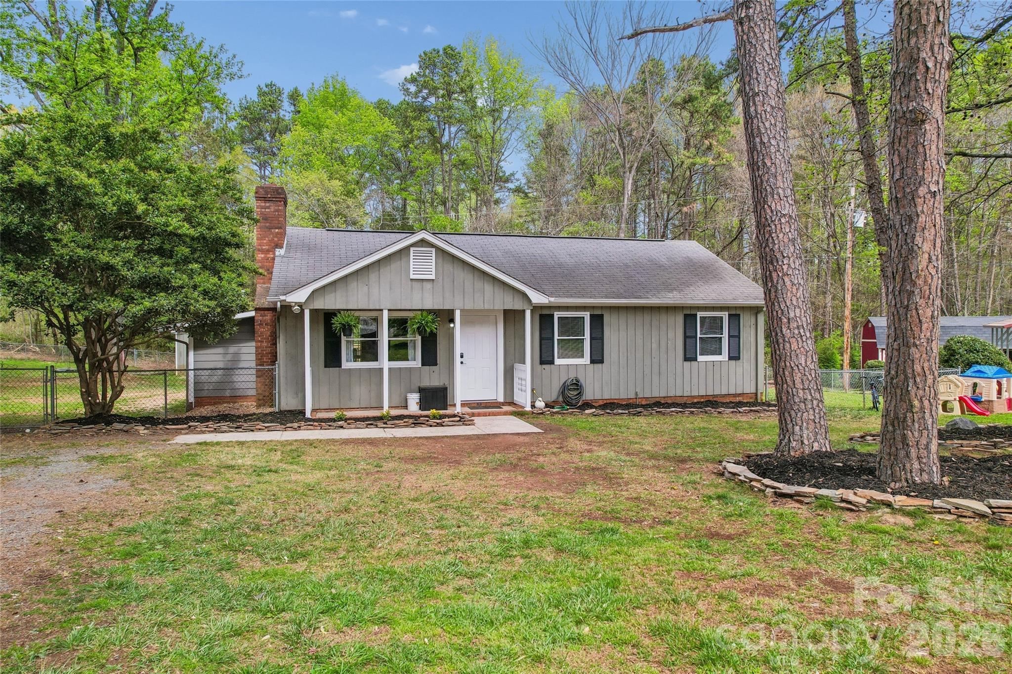 Welcome home to this charming ranch home nestled in the end of a quiet cul-de-sac lot. Close to all the amenities in Mint Hill, as well as 485, making your commute a breeze. Walk up to the inviting front porch, and step in to the open living room featuring vaulted ceilings and a wood burning fireplace. To the right, you’ll find the primary and secondary bedrooms, as well as the full bath and laundry. The kitchen features updated appliances and recently redone pantry. The converted sunroom/3 season room is currently being used as a mudroom and office space. Out back you’ll find a spacious, newly renovated deck overlooking a large, private fenced in lot. New gravel just delivered for the driveway and septic was pumped 3/6. No HOA, investors welcome!