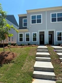 Discover the charm of this boutique townhome community built by Mungo Homes, a leader in quality craftsmanship & luxury design. This beautiful End-Unit two-story townhome features 3 bedrooms, 2.5 baths, & a rear-entry one-car garage, double size driveway, offering an open-concept layout with stylish upgrades finishes throughout. The main floor boasts luxury vinyl plank flooring, creating a seamless flow through the bright & airy living spaces. The chef’s kitchen is a standout, featuring a large sitting island w/ granite countertop, white cabinetry, tile backsplash, pendant lighting, & SS electric appliances! Upstairs, the spacious primary suite impresses w/ a boxed ceiling, generous walk-in closet, & a en suite bath w/ a quartz-topped dual vanity & a tiled walk-in shower. Two additional bedrooms, a full bath, & a convenient laundry closet complete the second level. Located just minutes from Uptown Charlotte, the airport, & shopping, Lakeview Village offers the perfect blend of style, comfort, & convenience. Ask about Move-in package & Financing Promotions! 2025 Parade of Homes GOLD Winner!