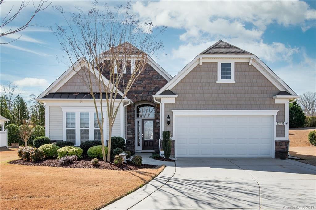 Elegant Willow Bend model. Spacious kitchen with granite counters, cabinet roll-outs, SS appliances, island bar, desk niche, pantry & breakfast nook. Open floorplan features great room with fireplace, diningroom & sunroom. Harwood floors throughout the main living space. Enjoy the outdoors on the rear covered patio and sitting wall with privacy and tree-lined view. Huge .31 lot in a cul-de-sac. 55+ active adult community