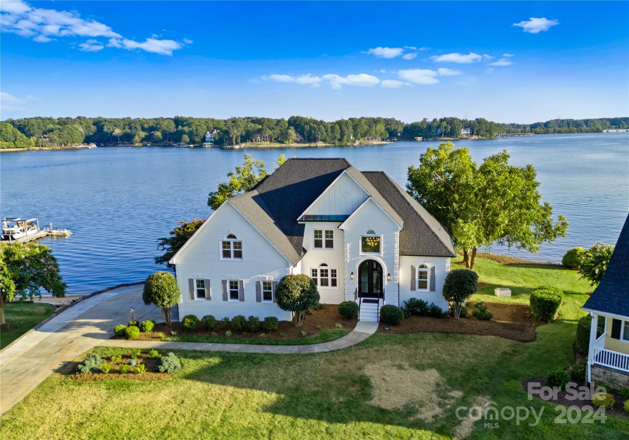 Welcome to this stunningly updated waterfront retreat on Lake Norman that seamlessly blends modern luxury w/ timeless elegance. This exquisite home showcases an impressive array of enhancements and meticulous upgrades, making it a true standout in the market. This 4 bed/5 bath residence features all-new windows, a custom 10-foot iron entrance door and powder-coated railings on both exterior & interior stairwells. Inside, enjoy fresh paint, designer finishes, and new engineered hardwood flooring. The open kitchen and living area boast quartz countertops/backsplash & luxury Bosch appliances. The main level includes a primary suite, w/ a second primary suite upstairs. Five bathrooms have been completely renovated w/ modern tile, cabinets and fixtures. The lower level boasts ample entertaining space. Step outside and soak in breathtaking views in the new Swim Spa, just steps from ~250 ft of Lake Norman shoreline, including a dock w/ gazebo, an oversized boat slip, and a boat lift.