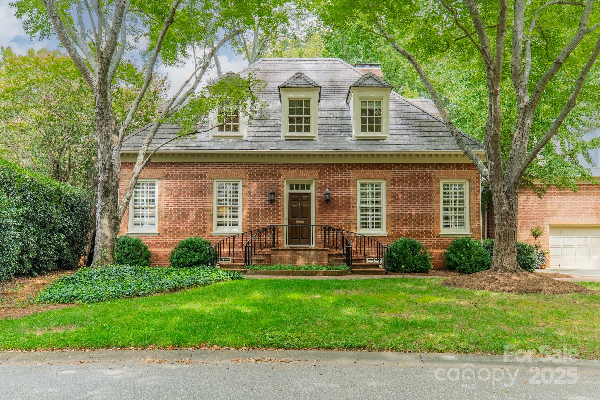 Located in the prestigious Eastover neighborhood, this exquisite residence combines timeless elegance with modern livability. Situated on a rare 1.25-acre lot, the home offers expansive open grounds framed by mature trees and protected by a sight easement, ensuring uninterrupted views and privacy.
Inside, soaring ceilings and an open floor plan create an inviting flow. Both the living room and dining room feature fireplaces, adding warmth and sophistication to the heart of the home. The primary suite is conveniently located on the main level, while upstairs you’ll find three spacious guest rooms—one with a private ensuite bath.
A unique highlight is the private guest quarters over the attached garage, complete with a kitchenette, ideal for extended stays or a home office retreat.
This is a rare opportunity to own a remarkable estate in one of Charlotte’s most coveted neighborhood