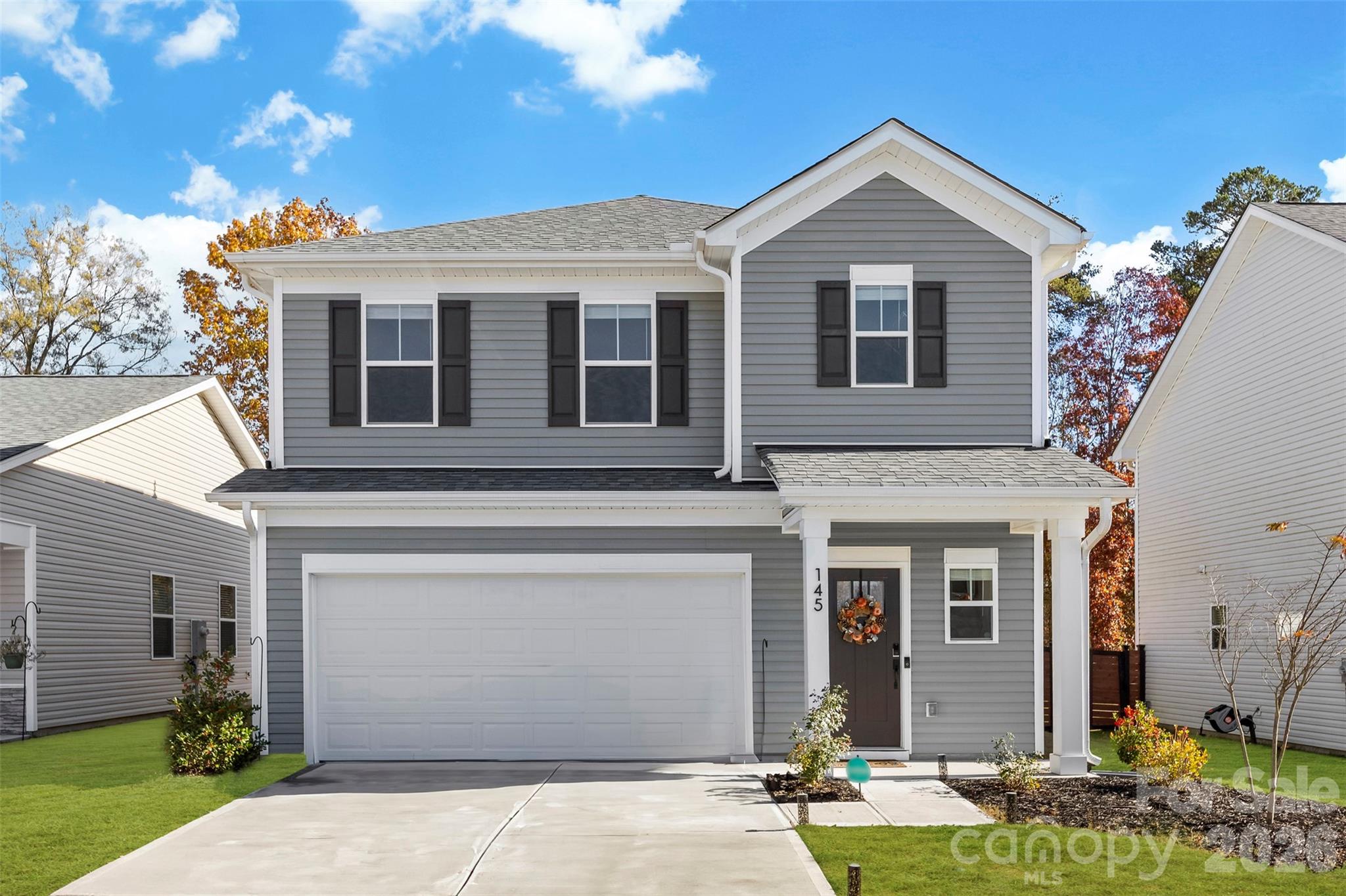 Welcome home to this beautifully maintained 3-bedroom, 2.5-bath residence tucked inside the Surrey Woods community. The main floor welcomes you with an open layout where the living room flows seamlessly into the dining area and kitchen, creating an inviting space for hosting, relaxing, or enjoying your favorite shows. The kitchen stands out with its white soft-close shaker cabinets, quartz countertops, and a stunning tile backsplash that pairs perfectly with the stainless steel appliances. The entire home features luxury vinyl plank flooring no carpet anywhere along with upgraded trim details, a stylish pedestal sink, enhanced fixtures, and thoughtful selections throughout. Upstairs, you’ll find all three bedrooms along with a dedicated laundry room (not a hallway laundry!), complete with built-in cabinetry and a recessed dryer vent for added convenience. Both full bathrooms offer quartz countertops atop soft-close white shaker vanities, continuing the clean and cohesive design. This home blends modern finishes with practical everyday living, creating a comfortable and well-appointed space ready to enjoy.