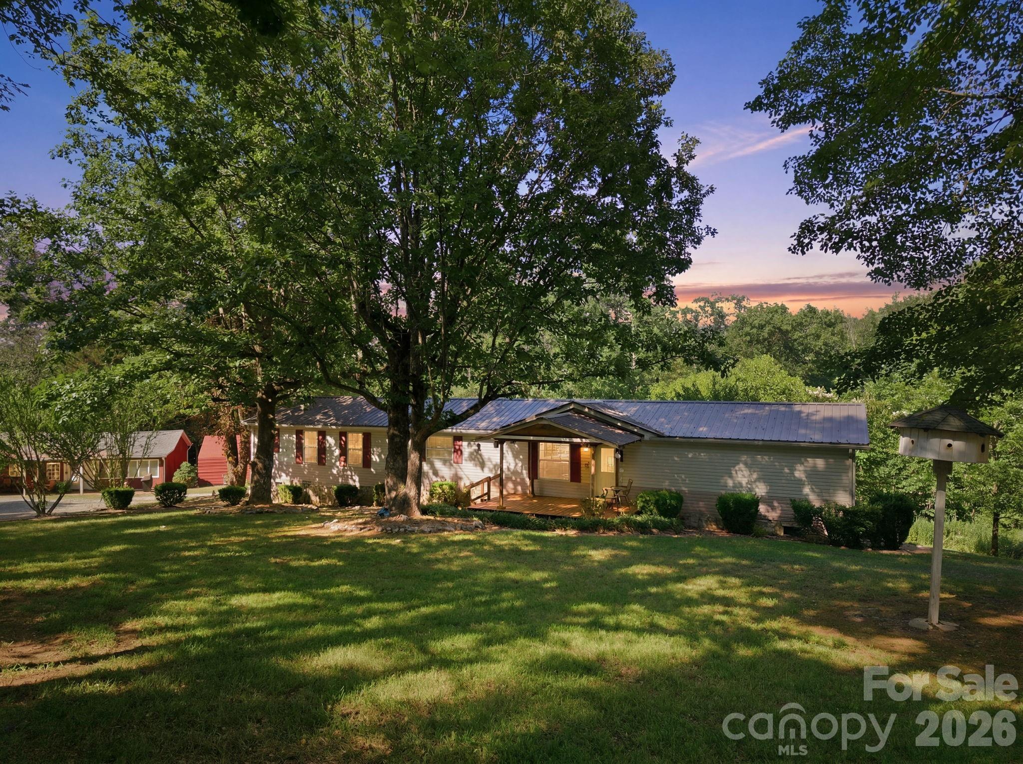 Rare opportunity to own a versatile mountain retreat featuring multiple furnished structures on 1.31 private acres with a creek running along the rear of the property. The property includes a 3-bedroom, 2-bath main home with a metal roof, an approximately 800 sq. ft. furnished cabin-style guest house, a tiny-home-style structure, a 20x20 fully insulated shed, and a 20x30 workshop.

The furnished structures are being sold fully furnished and equipped with smart TVs, furniture, stocked kitchens, linens, and washer/dryers, creating a truly turnkey opportunity from day one. Whether you're looking for a primary residence, multi-generational living setup, mountain getaway, or investment property, this unique property offers exceptional flexibility.

With multiple living spaces already in place, buyers may find opportunities for guest accommodations, long-term rentals, short-term rental potential, or income-producing uses subject to buyer verification and local requirements. The combination of the main home, cabin, tiny-home-style structure, workshop, and insulated shed creates a property that is difficult to replicate at this price point.

Enjoy peaceful outdoor living surrounded by mature trees, abundant privacy, a flowing creek, and mountain charm. Properties offering this much usable space, flexibility, and income potential rarely become available. Buyer to verify square footage, structures, restrictions, and intended uses.