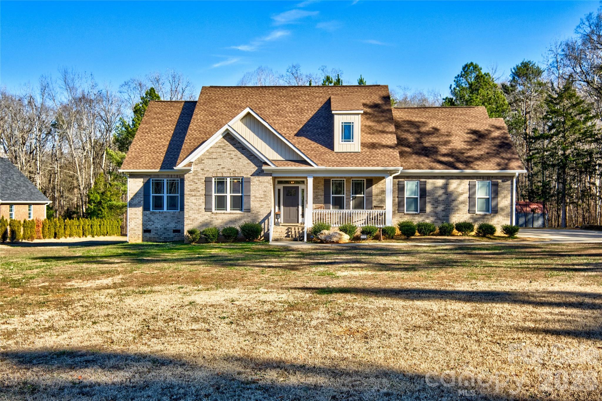 This is the one you have been waiting for in the award winning Clover School District and affordable price!  Almost new 4 bedrooms, 3 baths and on over 2 acres and close to Lake Wylie.  This semi custom home has everything you are looking for.  Split bedroom plan on 1st floor and guest suite/multigenerational living upstairs with full bath, large bedroom AND its own bonus room.  The amazing 3 lock glass slider opens the outside to come in from the screened porch.  Beautiful feature of this home.  Stacked stone fireplace and open concept floorplan finish the look.  Huge pantry and laundry room for even more storage. Chicken coop, raised beds, fire pit  and a storage unit fill the backyard for all your outdoor needs.  There is even a small stream running along the back of the property.  The sellers added extra concrete for additional parking.  The garage is oversized and room for all your toys.  Home offers full brick and lots of details.  This one has whole house generator and tankless water heater.  Come enjoy a country feel but close to everything. 30 minutes to Charlotte International airport and easy commute to Belmont, Gastonia, Rock Hill and Charlotte.  The rocking chair front porch awaits you!
Please be patient for appointment confirmation as seller works from home!!