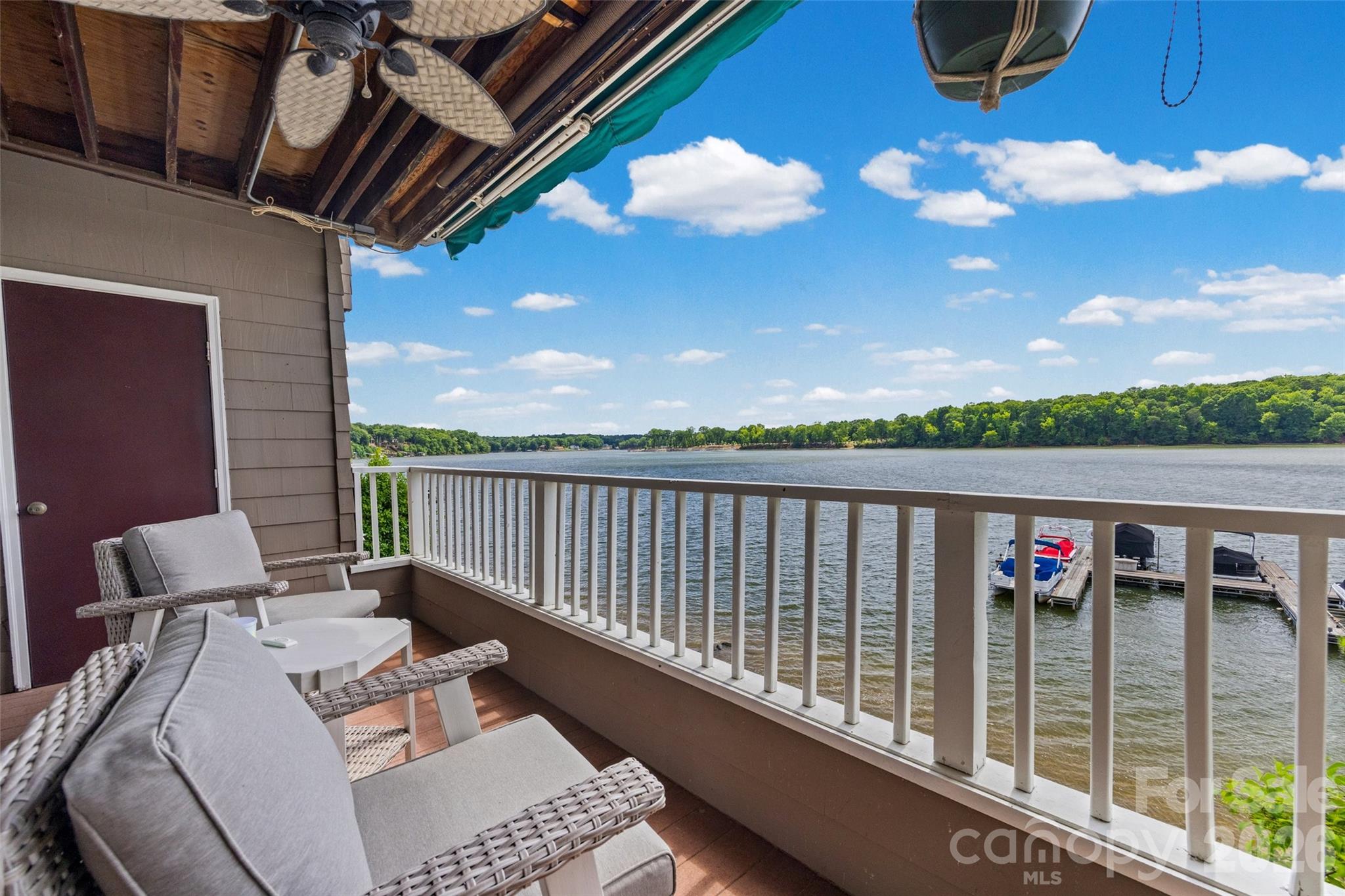 WOW! Panoramic main channel views of Lake Wylie and an assigned boat slip included! Experience lake life at its finest in this rare two-story waterfront condo at Emerald Point. This beautifully updated unit features new flooring, new stainless-steel appliances, updated fixtures, and fresh paint throughout. Enjoy breathtaking sunsets from either your upper or lower deck while taking in the expansive views of Lake Wylie. The unique lower-level living space is perfect for entertaining after a day on the water. Pull your boat into your dedicated slip, stroll along the boardwalk, and gather with friends at your private bar area. A spiral staircase connects both levels and provides access to the upper deck, creating the perfect indoor-outdoor lakefront lifestyle. Residents of Emerald Point enjoy fantastic amenities including a community pool, marina, kayak and paddleboard storage, and direct lake access. Conveniently located just minutes from the airport, Charlotte Premium Outlets, I-485, and a variety of shopping and dining options, this property offers the perfect combination of waterfront living and city convenience. Whether you’re looking for a full-time residence, a weekend getaway, or investment opportunity, this Lake Wylie gem is one you don’t want to miss!