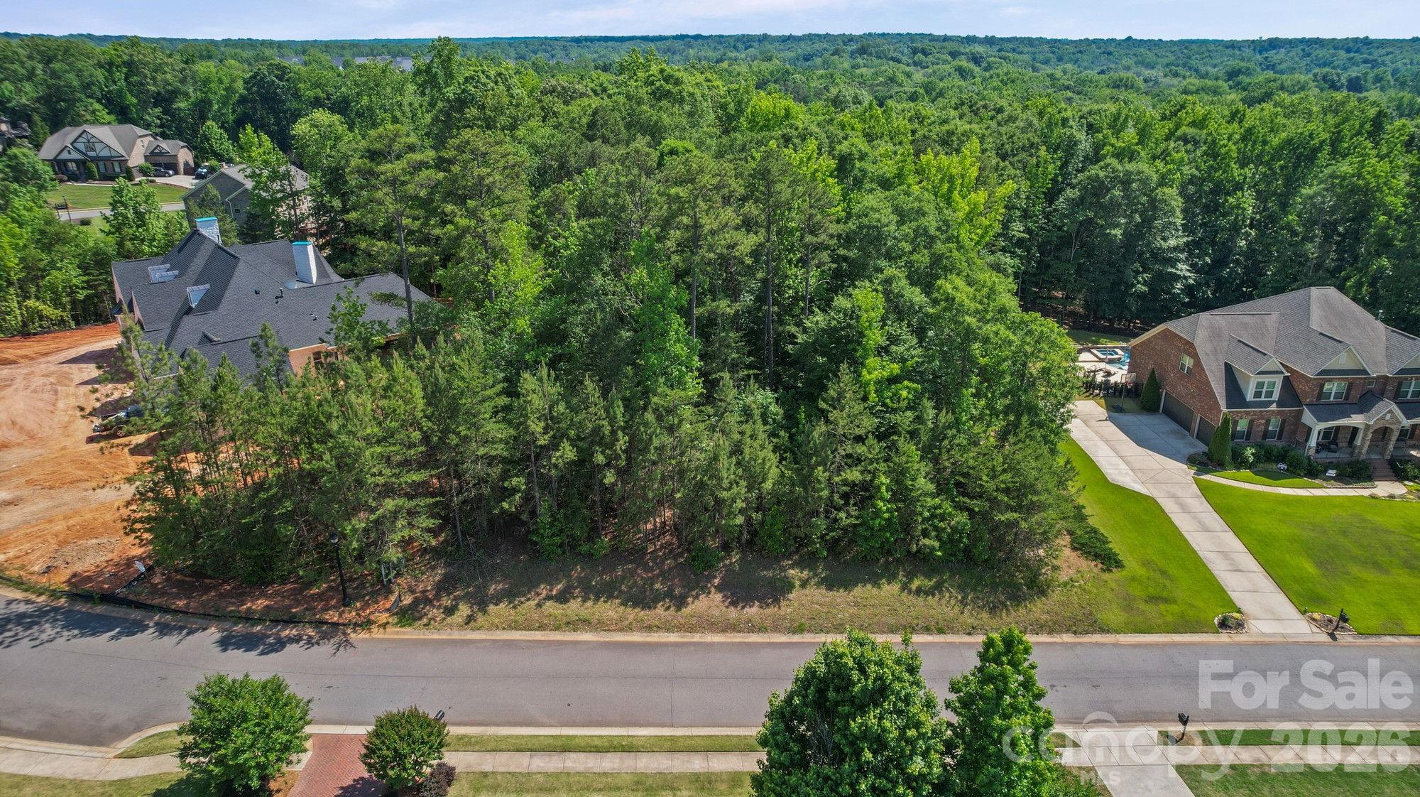 This nearly 1 acre lot is ready to build on and is located in a highly desired, beautiful gated community located just a few minutes from Ballantyne, but with the advantage of being in South Carolina. Build your 3500+ square foot house on this gorgeous lot with plenty of trees for privacy. Previous owner had planned to build with Grand Living Homes and the current owner planned on building with them. This is the last lot available in this community. The builder stated that this lot could be a crawl space or a basement depending on where you want to place the house and if you want to add a pool in the future will also determine if it would be a crawlspace or a basement. ARC must approve all building plans. Seller is related to listing agent.