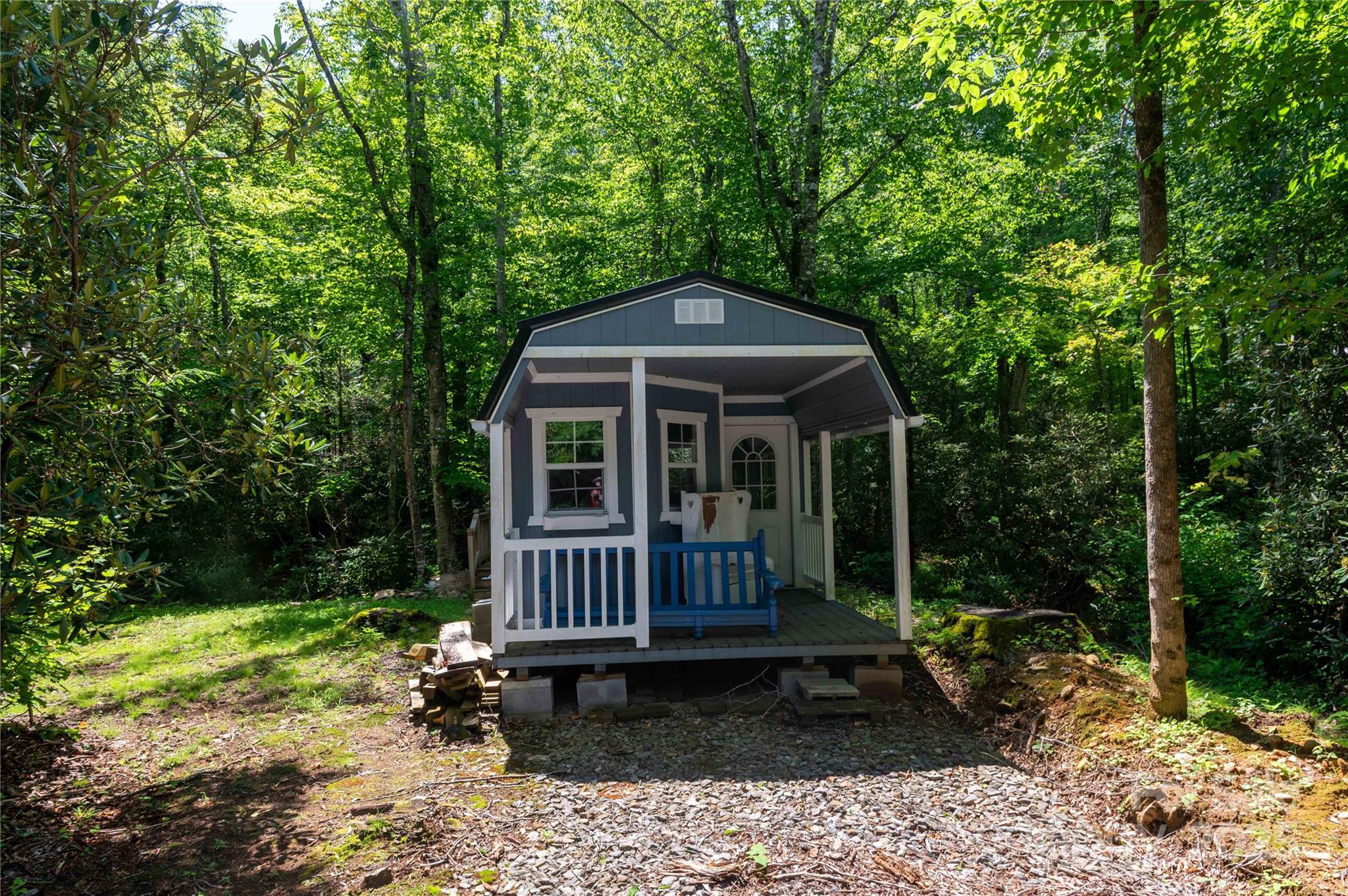 Tucked away on a quiet country road, this serene two-acre wooded property offers a perfect opportunity to create your own private retreat. Surrounded by trees and natural beauty, the land provides a peaceful, secluded setting ideal for a tiny home, weekend getaway, or future homestead. The property includes a partially completed tiny home, giving buyers a valuable head start while still allowing plenty of room for customization. The structure has been thoughtfully started and is ready for a new owner to finish to their vision. A natural spring flows on the property and feeds a charming tiny pond, adding both character and a tranquil atmosphere while attracting local wildlife. The land has already been perc tested and approved for a septic system, making it well-prepared for continued development. As an unrestricted property, it is also perfectly suited for RV living, camping, or temporary stays while you build, offering flexibility that is increasingly hard to find. With its gently wooded terrain, quiet surroundings, and minimal traffic, this property offers privacy without feeling isolated. One of the standout features of this property is its notably flat terrain. The level land makes it easy to place an RV, expand the tiny home, add outbuildings, create garden spaces, or design outdoor living areas with minimal site preparation. With its quiet surroundings, gentle landscape, and minimal traffic, this property offers privacy without feeling isolated. Whether you’re seeking a peaceful escape, an off-grid lifestyle, an RV-friendly getaway, or a unique building opportunity in nature, this wooded retreat provides the perfect balance of readiness and potential. Centrally located with Asheville, Boone, Blowing Rock, and Banner Elk only about an hour away, and the towns of Burnsville/Spruce Pine with their shopping and dining opportunities around 20 minutes away, you’re peacefully isolated but relatively close to conveniences. 
Don’t let this one slip away, book your showing today!