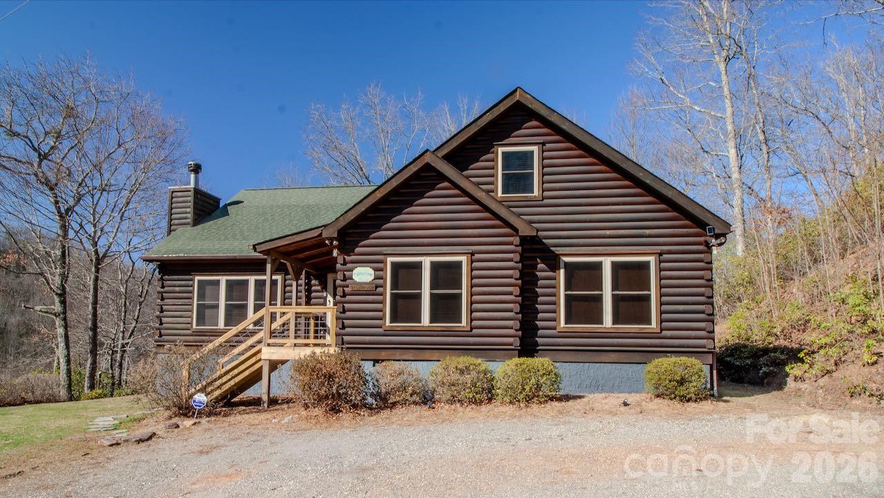 This is the cabin for you! Sold fully furnished! Come see this open concept Log Cabin where family stories unfold and enjoyment of each other's company is all that matters!  In a setting of calm, quiet, and long range mountain views with creek sounds in the background reconnect with one another. Cross over the Tuckaseegee River and travel down serene paved back country roads leading to your private retreat with almost 2 acres giving a feeling of being a world away yet you are minutes to Bryson City, Dillsboro/Sylva and Cherokee. Beautiful knotty pine inside and wide plank hardwood floors with tasteful log cabin decor surrounds you with the warmth only a log cabin can give. Kitchen has an island with a prep sink and lots of storage and countertop space.The great room with wood-burning fireplace opens up to the kitchen and dining area for maximum entertaining space. Through the French doors you will find a family room, large primary bedroom suite with doors leading out to the covered rear deck providing convenient access to the six person hot tub and fire pit area. Two more spacious bedrooms & full bath complete the main floor. Upstairs is a finished bonus room with sleeping area and game room with billiards and game console. Sold fully furnished with tasteful cabin decor so bring your toothbrush and get busy mountain living! Short term rentals allowed.